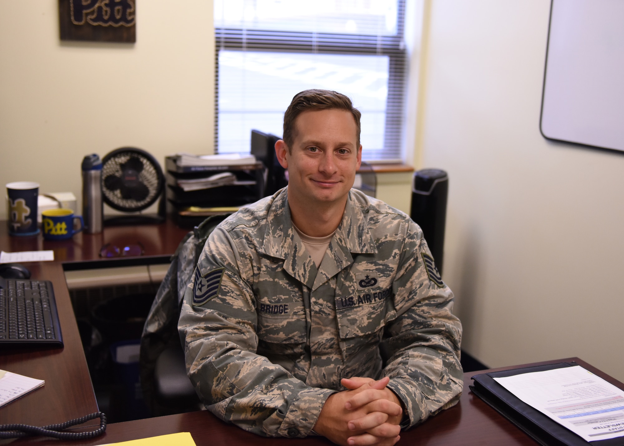 Tech. Sgt. Joseph Bridge, budget analyst with the 911th Financial Management Office, poses for a photo in his office at the Pittsburgh International Airport Air Reserve Station, Pennsylvania, Nov. 3, 2018. As a budget analyst, Bridge looks at the legality of finances and watches how all the wing’s money is used. (U.S. Air Force photo by Senior Airman Grace Thomson)