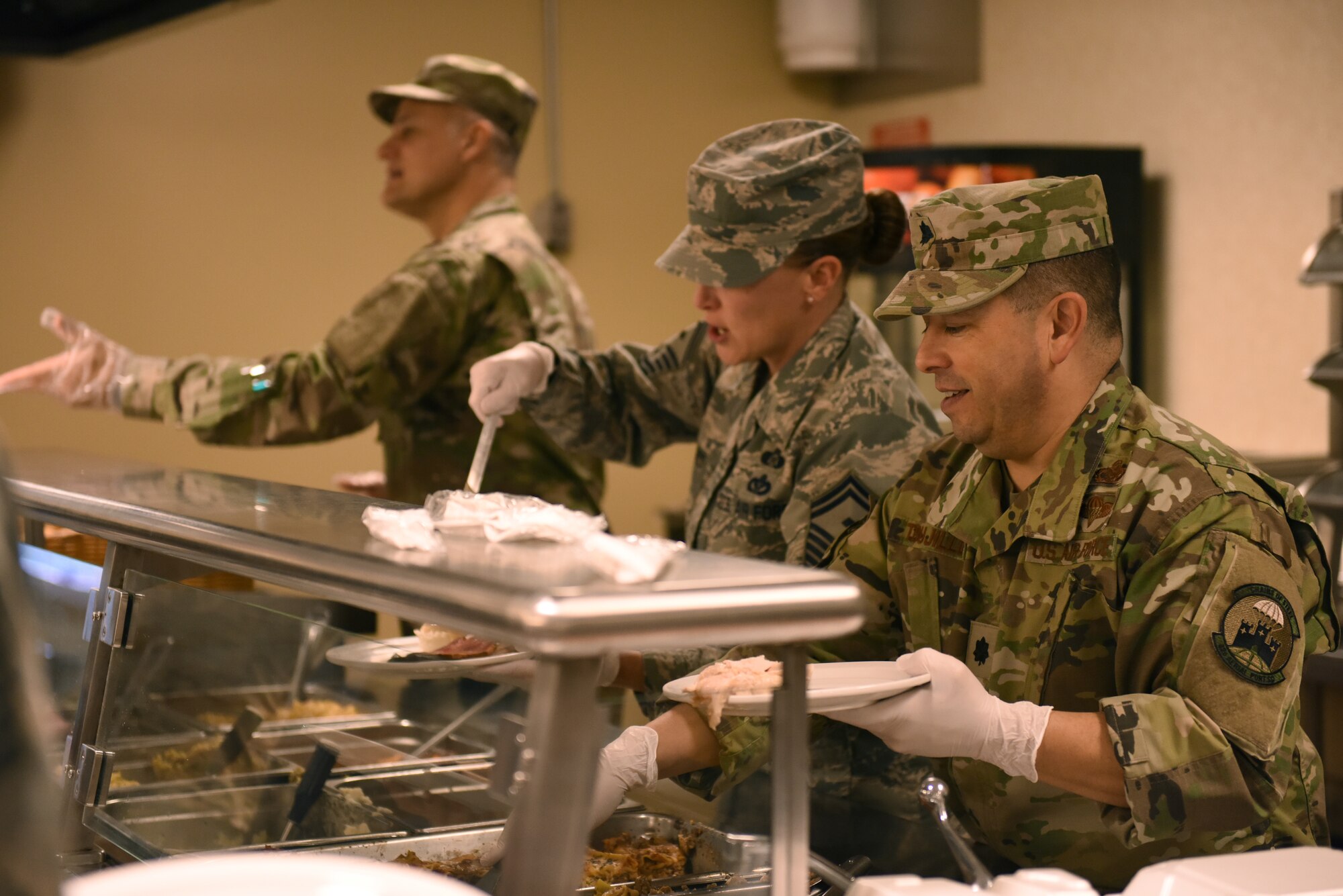 Col. Jay D. Miller, vice commander of the 911th Airlift Wing, Senior Master Sgt. Jessica E. Davis, first sergeant of the 32nd Aerial Port, and Lt. Col. Reginald G. Trujillo, commander of the 32nd Aerial Port Squadron, serve a Thanksgiving lunch to Airmen at the Pittsburgh International Airport Air Reserve Station, Pennsylvania, Nov. 3, 2018. Base leadership used this time to promote teamwork and camaraderie among the entire base. (U.S. Air Force photo by Senior Airman Grace Thomson)