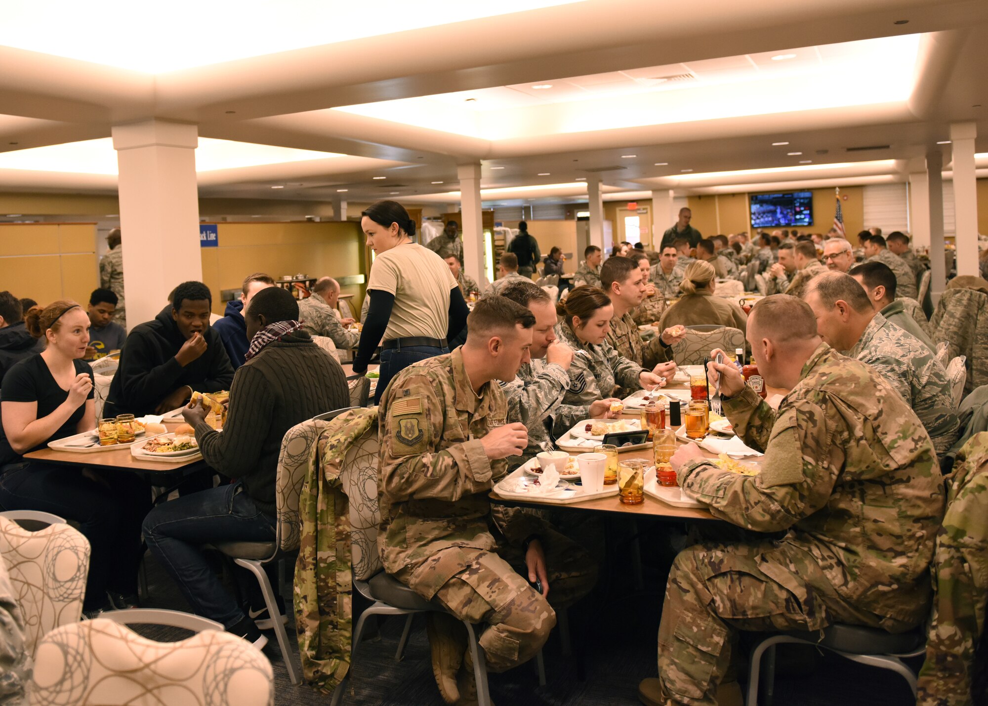 Airmen of the 911th Airlift Wing eat a Thanksgiving lunch at the Pittsburgh International Airport Air Reserve Station, Pennsylvania, Nov. 3, 2018. Every year during the November unit training assembly, there is a Thanksgiving lunch that is typically served by base leadership as a thank-you to the Airmen who work on the base. (U.S. Air Force photo by Senior Airman Grace Thomson)