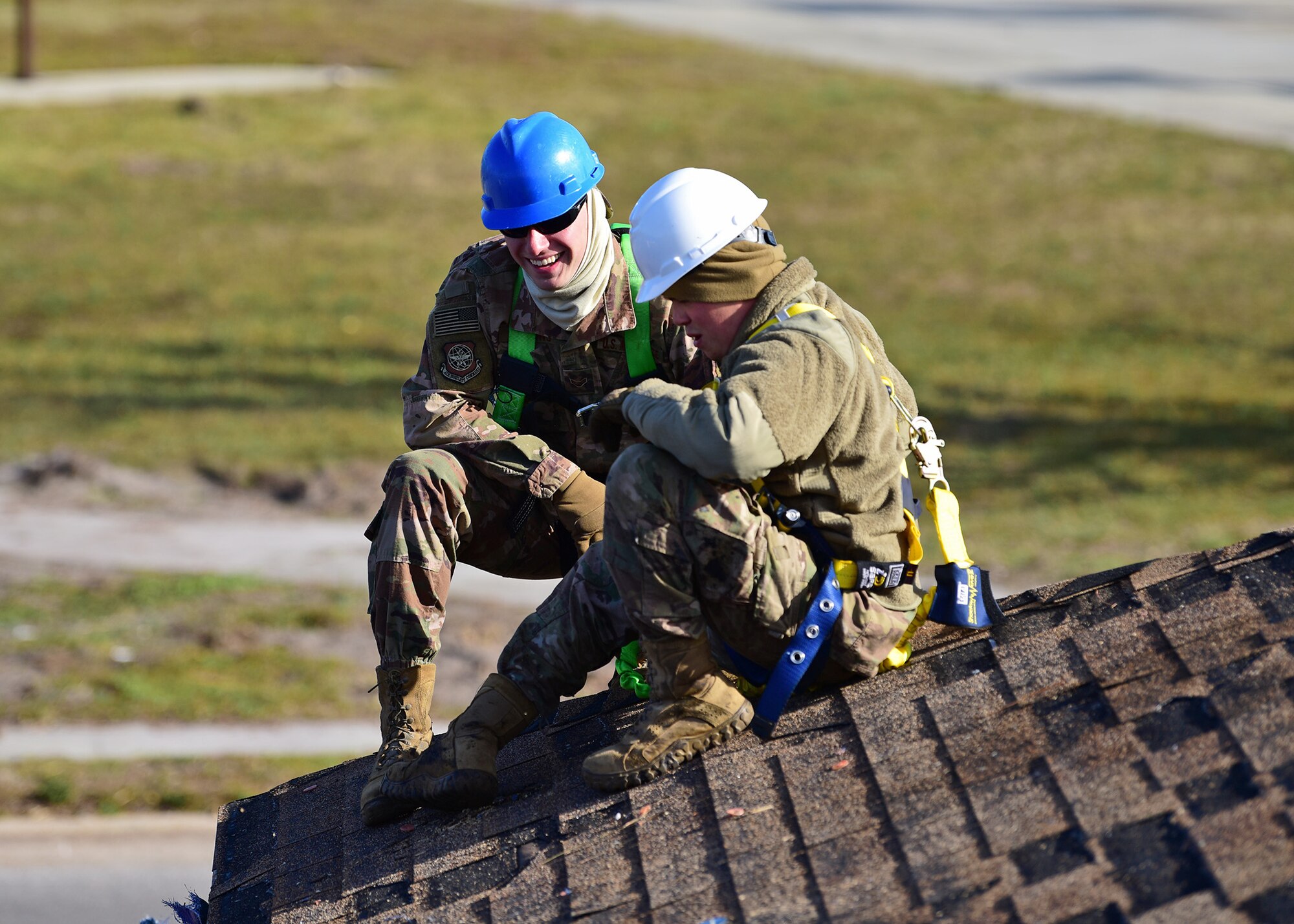 Task Force Phoenix members Airman 1st Class Marc Karns, left, and Senior Airman Jake Stauffer, right, pause for a moment while repairing a damaged rooftop at Tyndall Air Force Base, Fla., Nov. 28, 2018. Task Force Phoenix is tasked with large-scale cleanup and reconstruction of the base in the wake of Hurricane Michael. (U.S. Air Force photo by Senior Airman Isaiah J. Soliz)
