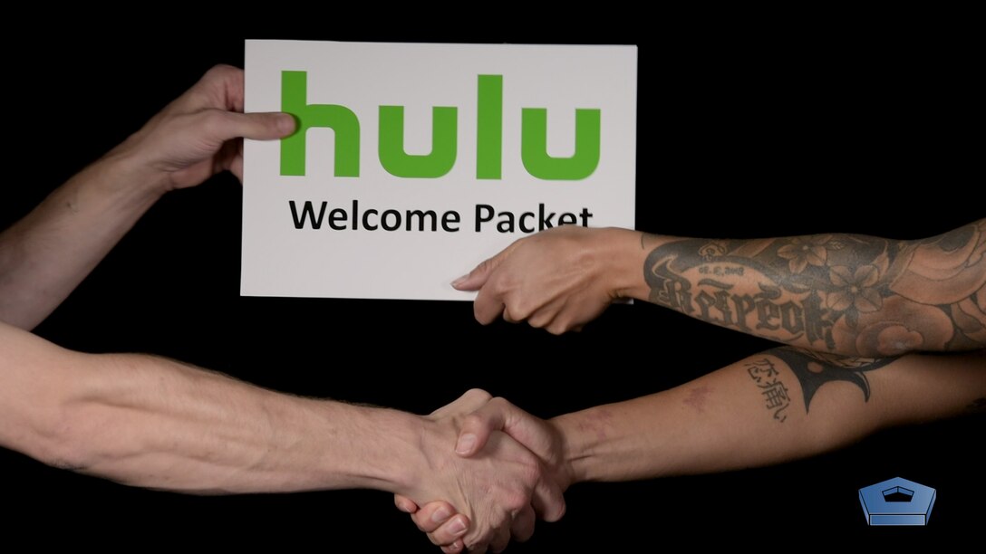 Two people's hands passing a packet to each other