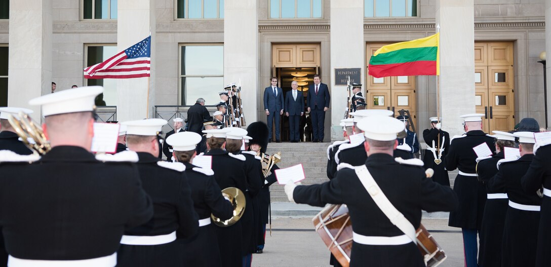 U.S. secretary of defense stands on top of steps with Lithuania's minister of defense
