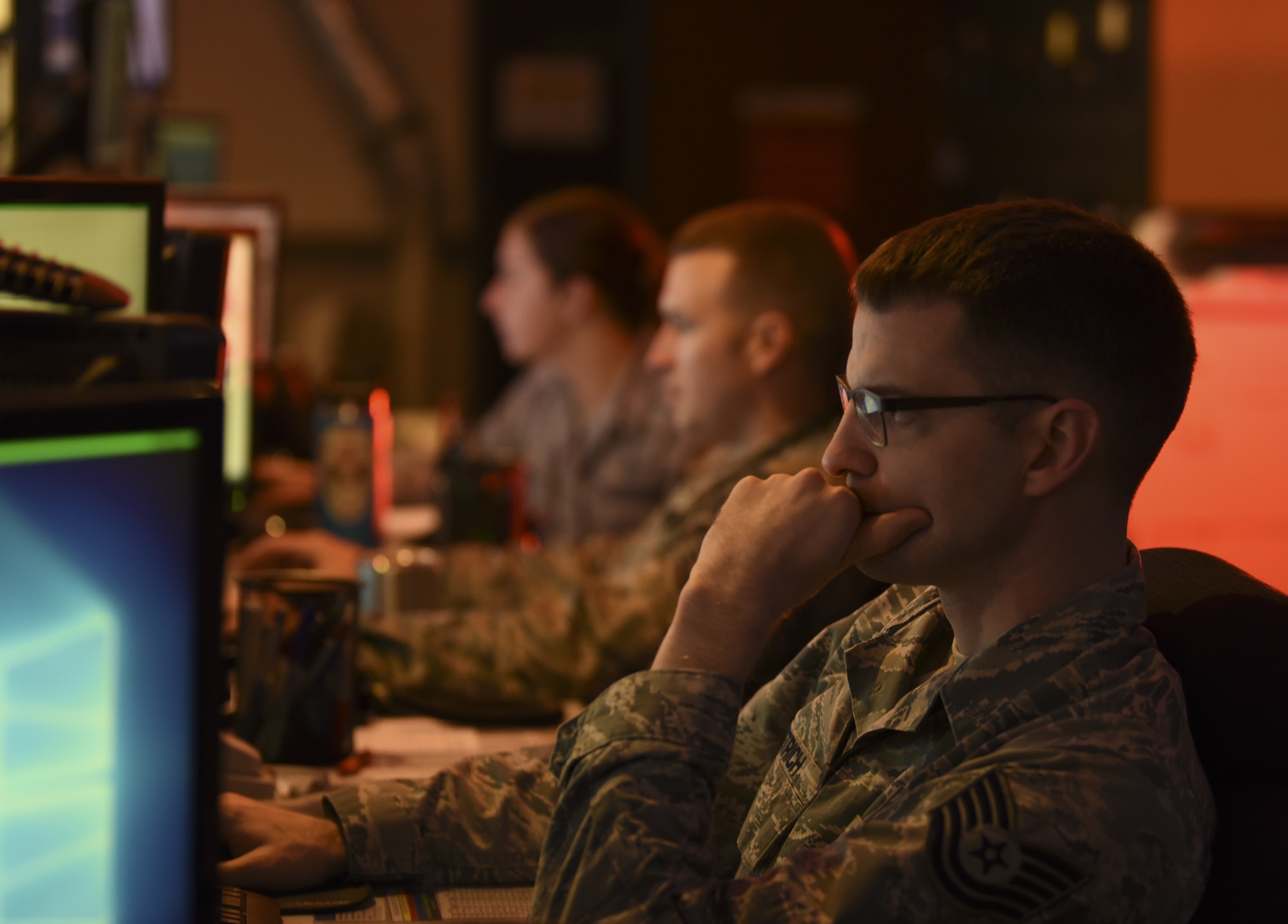 U.S. Air Force Tech. Sgt. Barron Dietrich, 60th Air Mobility Wing Command Post emergency actions controller, monitors his computer and Siemens communication console Nov. 21, 2018, at Travis Air Force Base, California. The command post tracks up to 30 flights per day at the largest base in Air Mobility Command. (U.S. Air Force photo by Staff Sgt. Amber Carter)