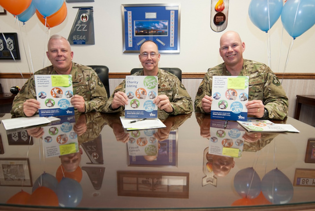 (Lef to right) Col. Christopher King, 377th Air Base Wing Vice Commander, Col. Richard Gibbs, 377th ABW Commander, and 377th ABW Command Chief Chief Master Sgt. Robert Stamper display their 2018 Combined Federal Campaign brochures Nov. 26, 2018, at the 377th Air Base Wing headquarters. Base leadership kicked off the installation’s 2018 CFC drive with a pledge-signing ceremony. The six-week campaign will run through Jan. 4, 2019 with a theme of “Show Some Love.”
