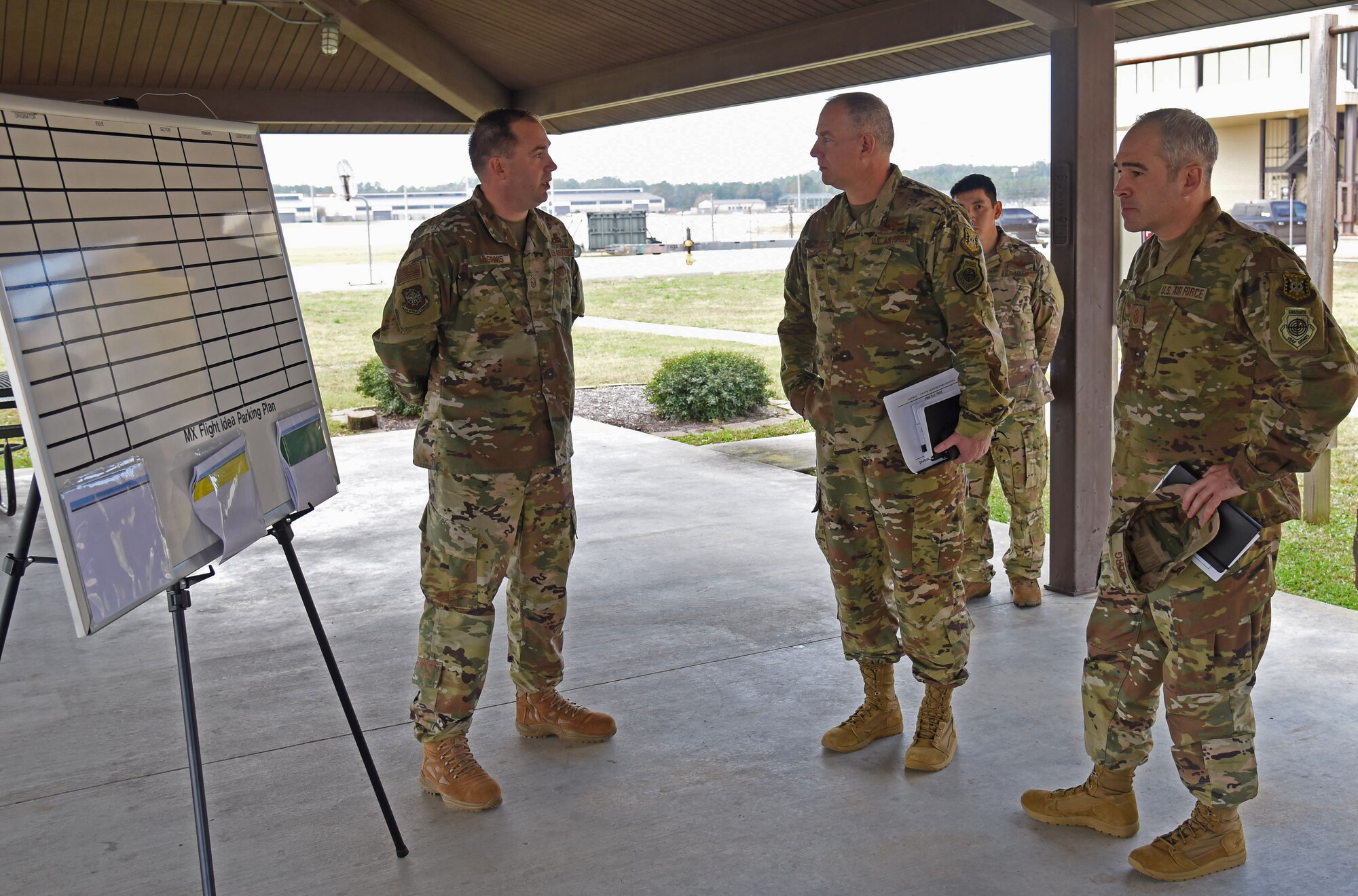 Maj. John R. Gordy II, U.S. Air Force Expeditionary Center commander and Command Chief Master Sgt. Kristopher K. Berg, USAF EC command chief, meet with an Airman from the 43rd Air Mobility Operations Group at Pope Army Airfield Nov.20, 2018. (U.S. Air Force photo by Tech. Sgt Jamie Powell)