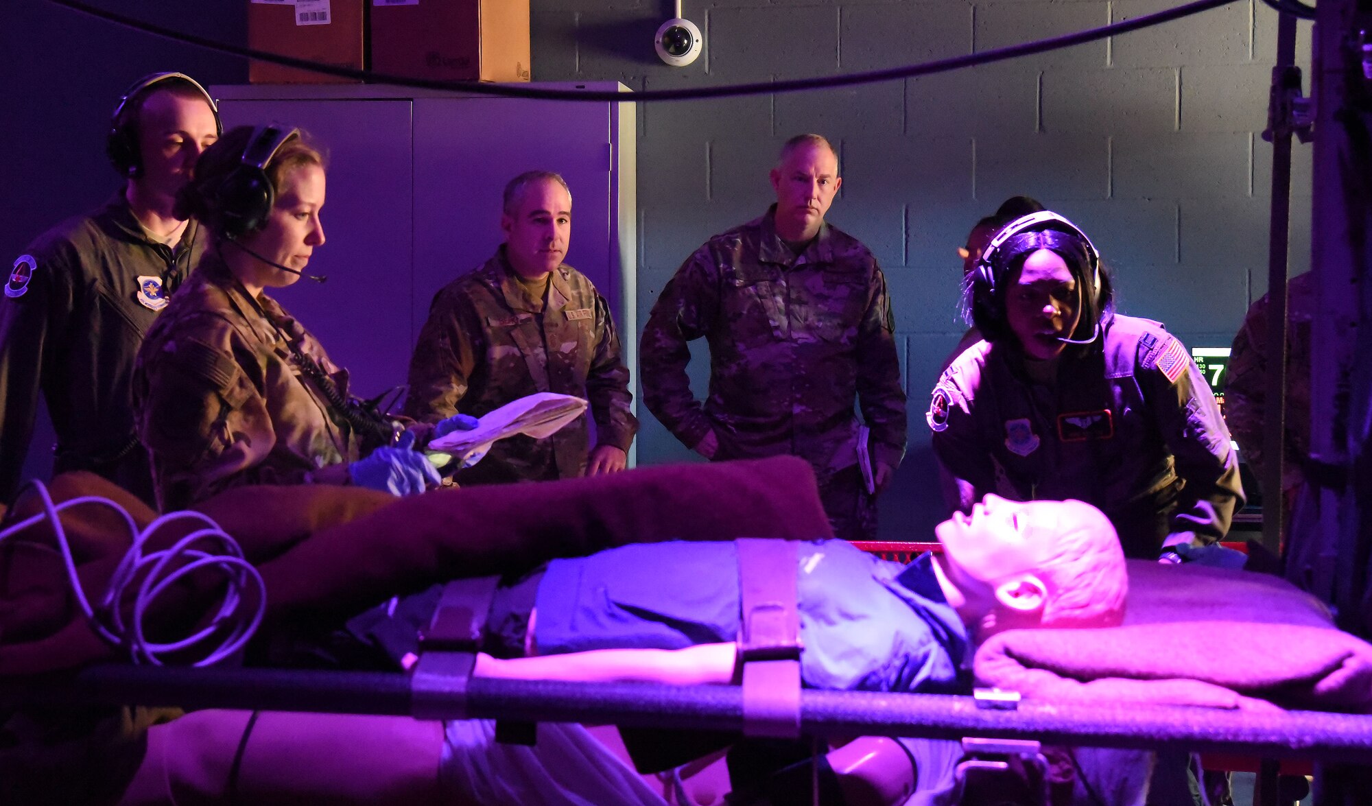 Airmen with the 43rd Aeromedical Evacuation Squadron demonstrate for Maj. Gen. John R. Gordy II, commander, USAF Expeditionary Center and Command Chief Master Sgt. Kristopher K. Berg, USAF EC command chief how they train on a C-130 Hercules simulator at Pope Army Airfield, N.C., Nov. 21, 2018. (U.S. Air Force photo by Tech. Sgt. Jamie Powell)