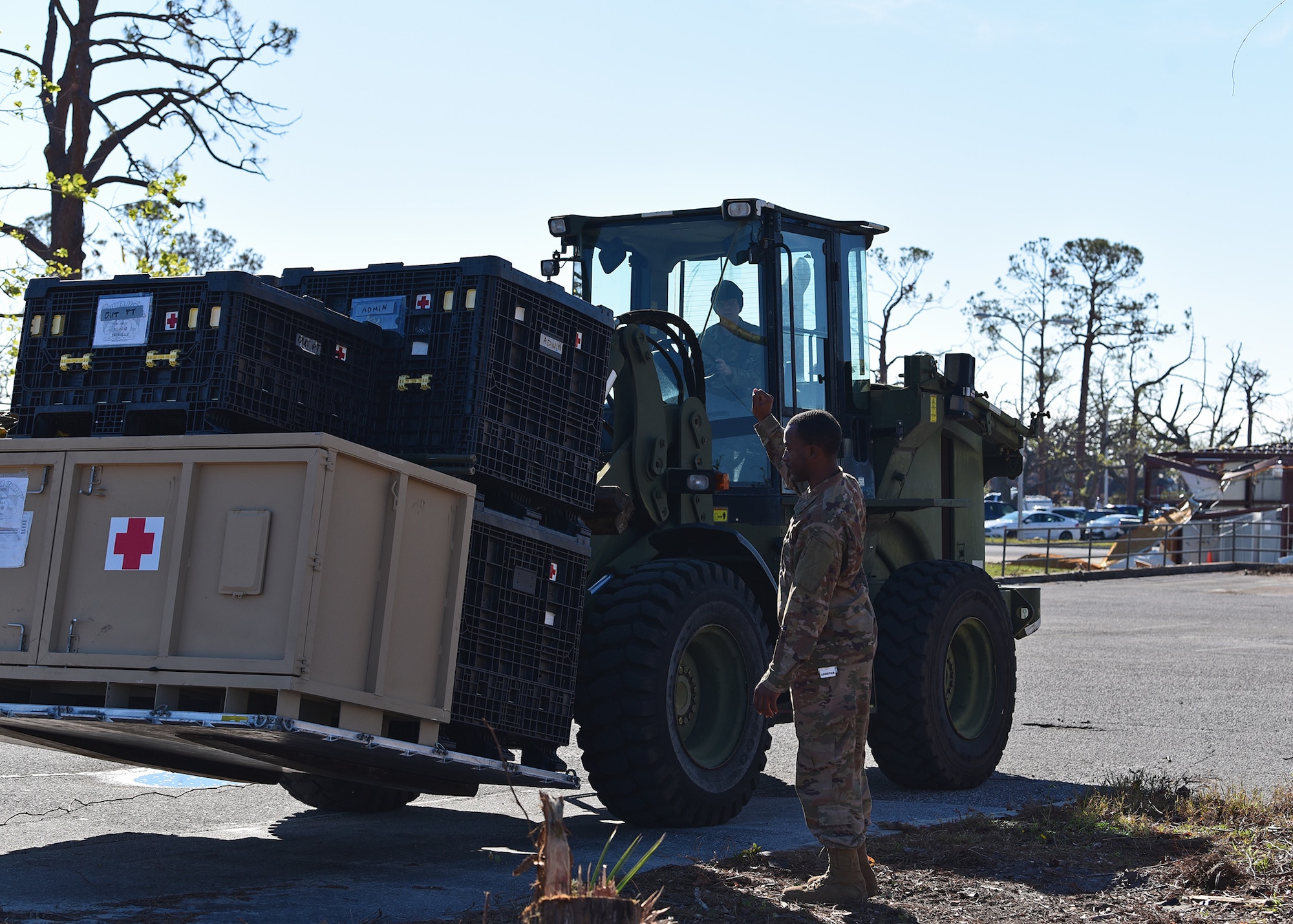 Staff Sgt. Dock Newell, 325th Medical Support Squadron medical material noncommissioned officer in charge, directs Airman Christian Myers, 1st Special Operations Logistics Readiness Squadron vehicle operator, where to stage a pallet of outpatient medical equipment at Tyndall Air Force Base, Fla., Nov. 27, 2018. Large-scale recovery efforts have continued in the weeks since Hurricane Michael struck the Florida panhandle and Tyndall AFB. (U.S. Air Force photo by Senior Airman Isaiah J. Soliz)
