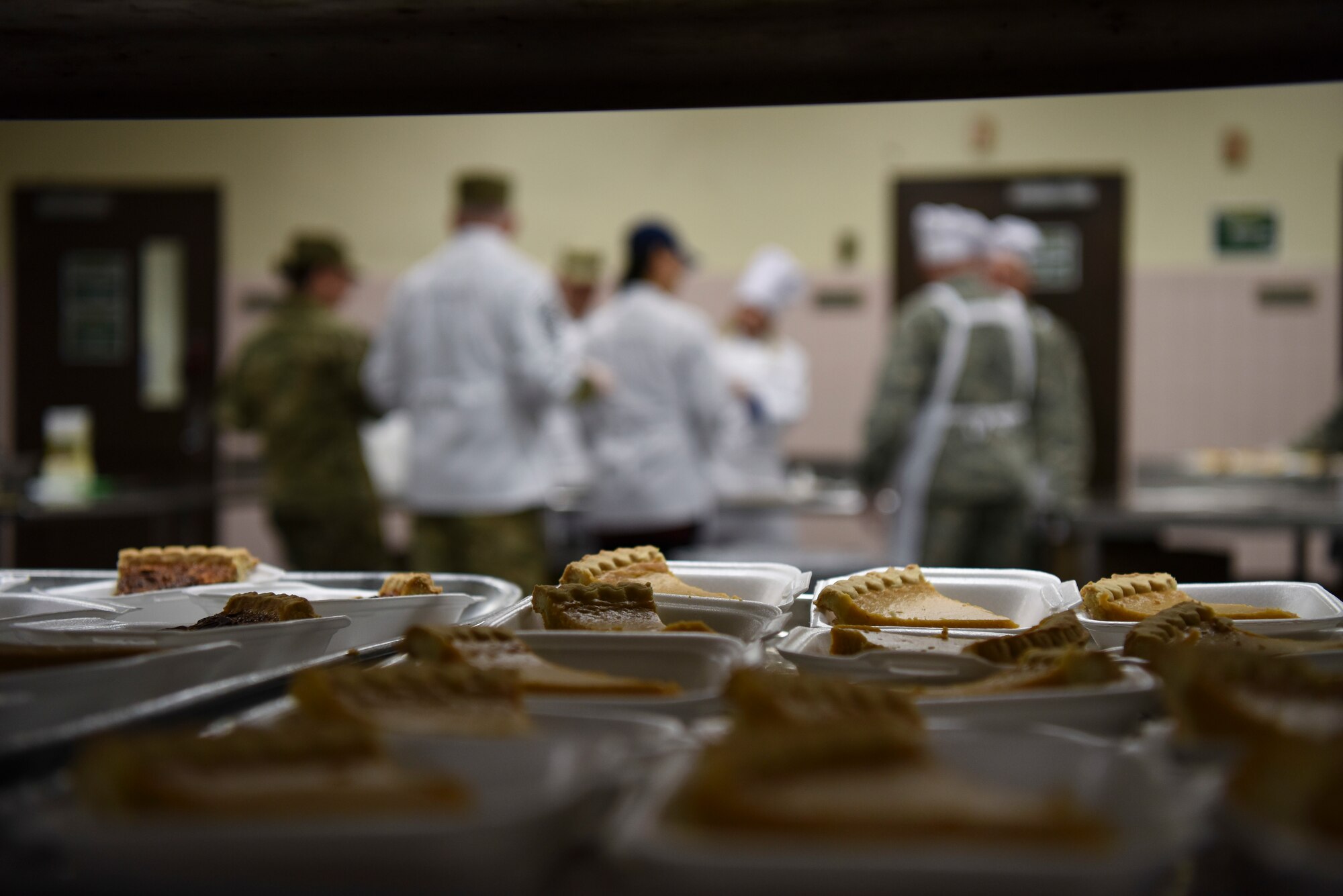 Leadership from both the 8th Fighter Wing and Seventh Air Force prepare pumpkin pie at Kunsan Air Base, Republic of Korea, Nov. 22, 2018. Lt. Gen. Kenneth Wilsbach, his wife, Cynthia, and other Seventh Air Force leadership joined base leadership as they prepared and served a Thanksgiving meal to Airmen. (U.S. Air Force photo by Senior Airman Savannah L. Waters)