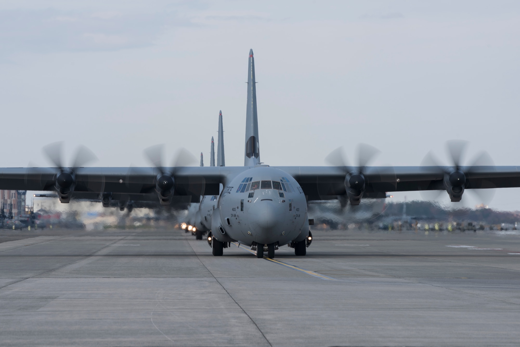 Multiple C-130J Super Hercules aircraft with the 36th Airlift Squadron taxi on the flight line during the 374th Airlift Wing Samurai Surge at Yokota Air Base, Japan, Nov. 29, 2018.
