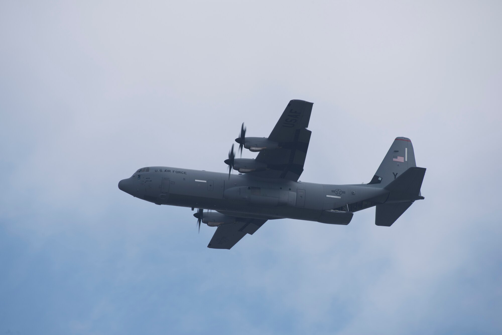 A C-130J Super Hercules aircraft with the 36th Airlift Squadron flies above the flight line during the 374th Airlift Wing Samurai Surge at Yokota Air Base, Japan, Nov. 29, 2018.