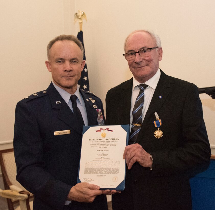 U.S. Air Force Maj. Gen. John Williams, Mobilization Assistant to the commander, U.S. Air Forces in Europe and Africa, presents the U.S. Air Medal to Swedish air force Col. Lars-Erik Blad in Stockholm, Sweden, Nov. 28, 2018. The Swedish pilots were awarded the U.S. Air Medal for their actions on June 29, 1987. (U.S. Air Force Photo by Senior Airman Kelly O'Connor)