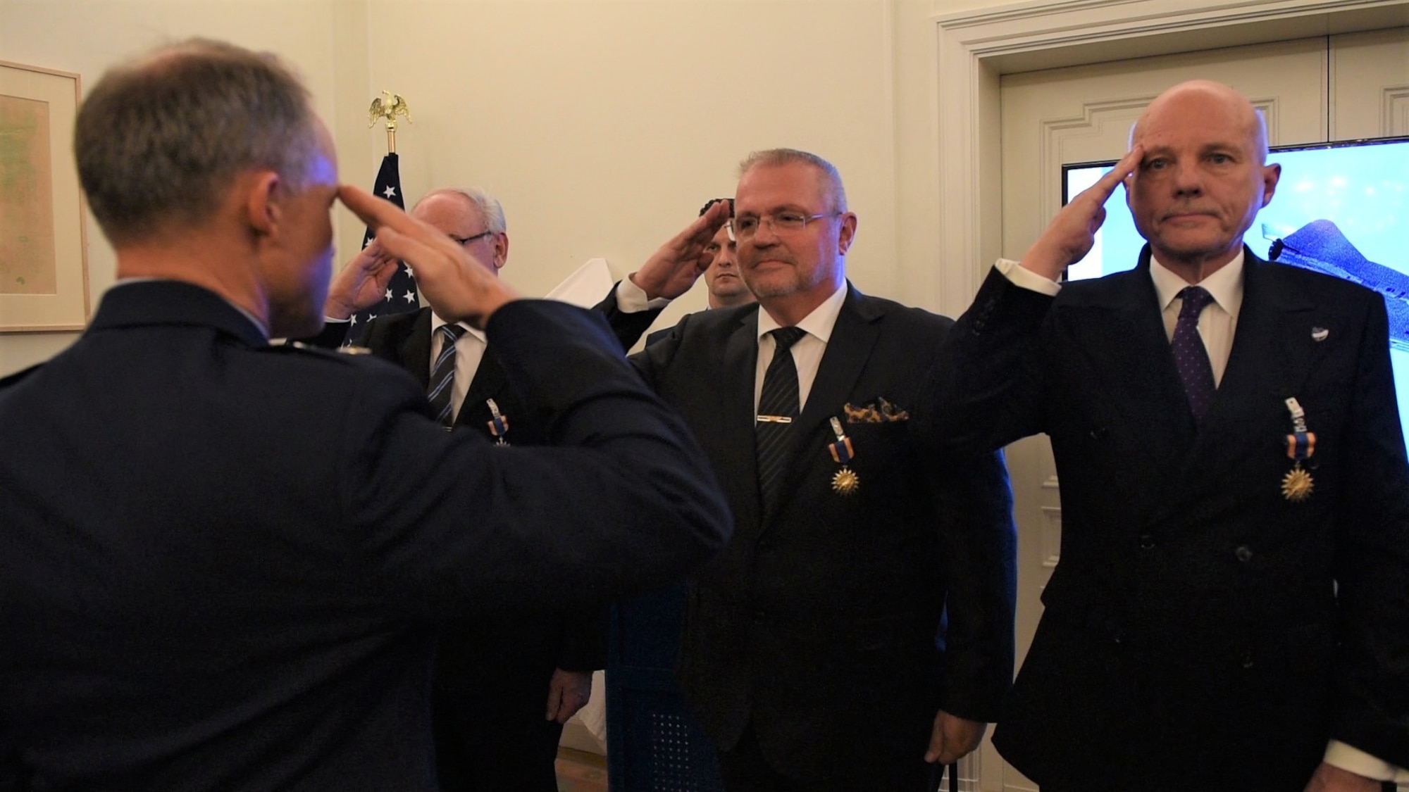 U.S. Air Force Maj. Gen. John Williams, Mobilization Assistant to the commander, U.S. Air Forces in Europe and Africa, salutes the Swedish pilots who are being awarded the U.S. Air Medal in Stockholm, Sweden, Nov. 28, 2018. Gen. Williams thanked the four Swedish Airmen who risked their lives to save an SR-71 and the aircrew in 1987. (U.S. Air Force Photo by Senior Airman Kelly O'Connor)