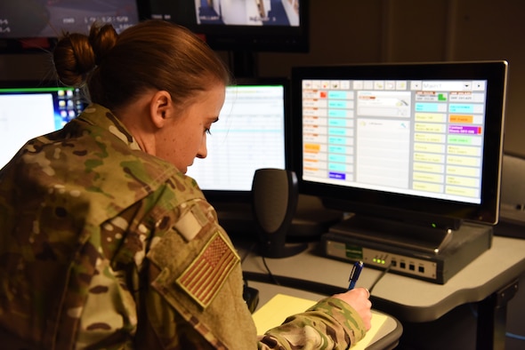 U.S. Air Force Tech. Sgt. Elizabeth Lefaive, 100th Air Refueling Wing Command Post NCO-in-charge of command and control readiness, looks over emergency notification systems in the command post at RAF Mildenhall, England, Nov. 27, 2018. Lefavie, along with Airman 1st Class Kalie Lyons, 100th ARW Command Post emergency action controller, were tasked with keeping information flowing to the appropriate shops and leadership through the day if need arises. (U.S. Air Force photo by Airman 1st Class Brandon Esau)