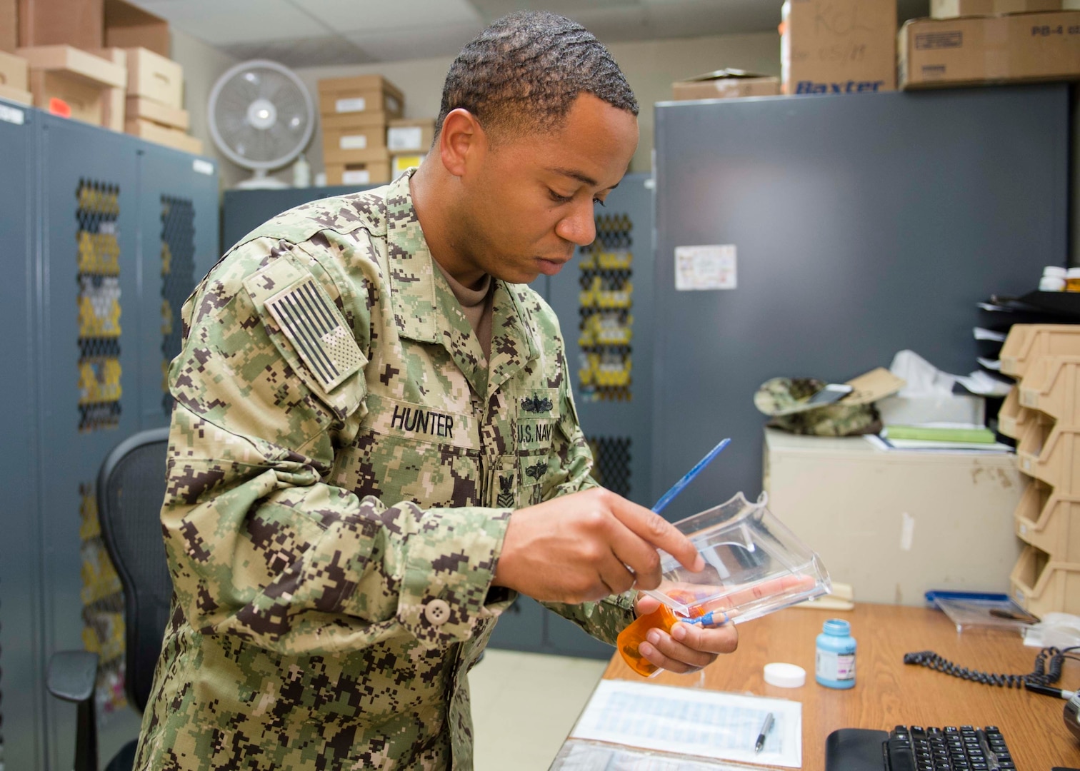 Hospital Corpsman 1st Class Travis Hunter fills a prescription at the Expeditionary Medical Facility on Camp Lemonnier, Djibouti, Oct. 3, 2018.