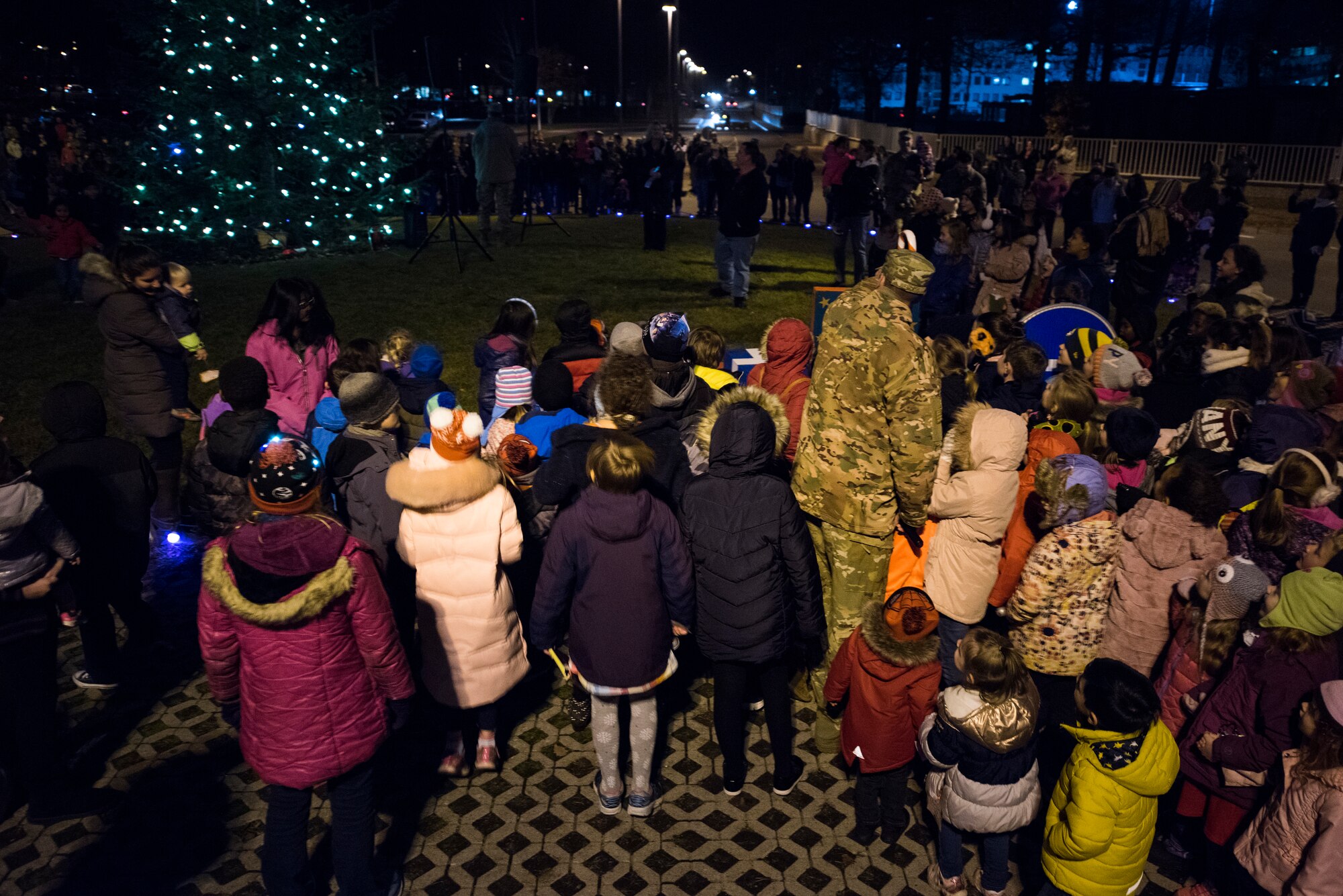 U.S. Air Force Col. Joseph Wenckus, 86th Airlift Wing vice commander, lights up the Ramstein Christmas Tree during the annual lighting ceremony on Ramstein Air Base, Germany, Nov. 27, 2018. The ceremony has been held since 2010 to affirm the ever-growing partnership between Ramstein-Miesenbach and Ramstein Air Base. (U.S. Air Force photo by Senior Airman Devin M. Rumbaugh)