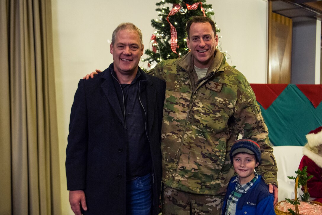 U.S. Air Force Col. Joseph Wenckus, 86th Airlift Wing vice commander, and his son, right, pose for a photo with Ralf Hechler, mayor of the union community of Ramstein-Miesenbach during Ramstein’s annual Christmas Tree Lighting Ceremony on Ramstein Air Base, Germany, Nov. 27, 2018. The city of Ramstein-Miesenbach gave Ramstein Air Base the Christmas tree in 2010, to show the ever-growing partnership between the base and the community. (U.S. Air Force photo by Senior Airman Devin M. Rumbaugh)