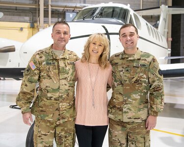 U.S. Army Chief Warrant Officer 5 Jeffrey Lohr, a C-12 master aviator and certified flight instructor assigned to Detachment 28 Operational Support Airlift Command, West Virginia Air National Guard in Williamstown, W.Va.,  poses with his wife Vicki Lynn and son Sgt. Nicholas Lohr, a crew chief with Company C, 1/150th Assault Battalion in Wheeling, W.Va., at the conclusion of his promotion ceremony held Nov. 16, 2018, at the West Virginia National Guard Armory in Williamstown, W.Va.