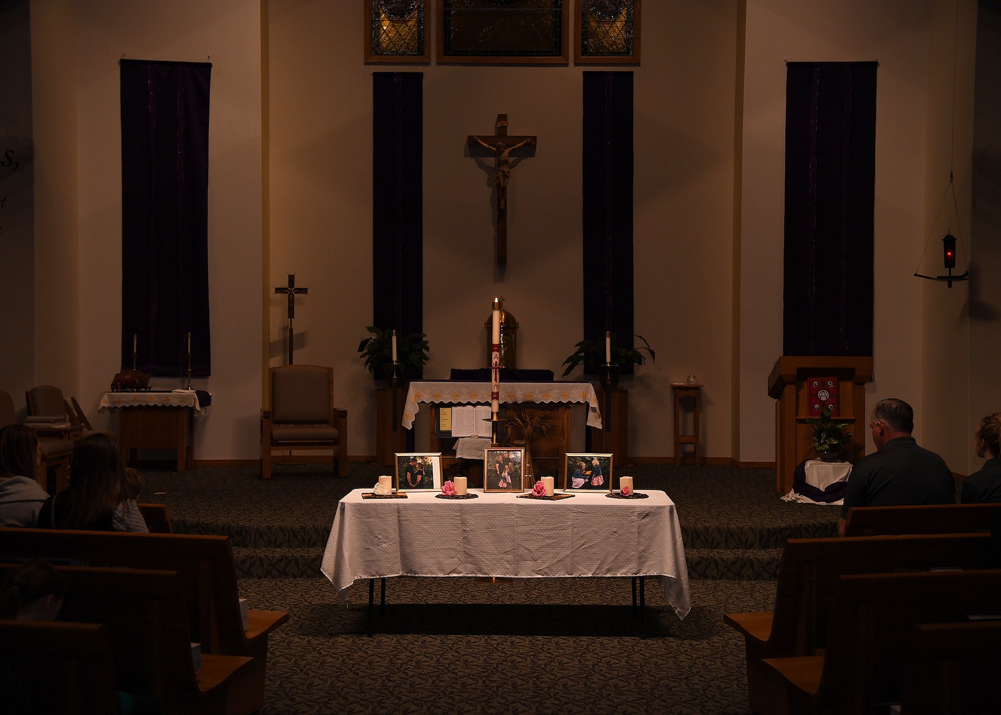 Photos of the Dean family are displayed atop a table at a vigil November 28, 2018, in St. Timothy’s Catholic Church, in Manvel, North Dakota. The vigil was hosted to honor the memories of Staff Sgt. Anthony James Dean, his wife Chelsi Kay Dean, and their two children Kaytlin Merie Dean, 5, and Avri James Dean, 1, who were killed in a vehicle accident Billings, Montana, during the Thanksgiving Holiday. The vigil was attended by nearly 100 family members, friends and coworkers from base, the Manvel Fire Department and members of the local communities. (U.S. Air Force photo by Airman 1st Class Elora J. Martinez)