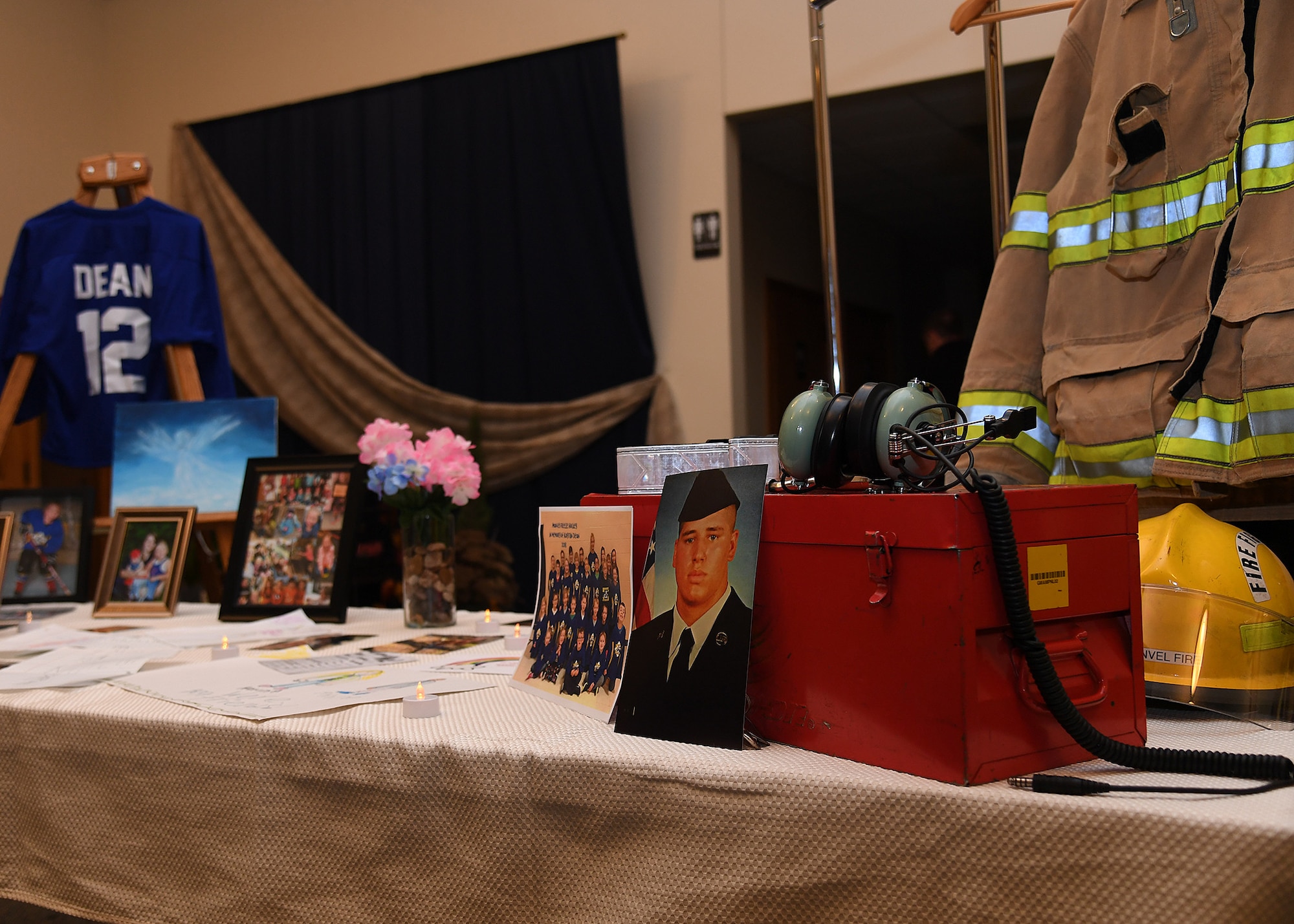 Photos and mementos of the Dean family are displayed near the entrance of a vigil hosted November 28, 2018, in St. Timothy’s Catholic Church, Manvel, North Dakota. Staff Sgt. Anthony James Dean, his wife Chelsi Kay Dean, and their two children Kaytlin Merie Dean, 5, and Avri James Dean, 1, were all killed in a vehicle accident during the Thanksgiving holiday near Billings, Montana. The family only recently were stationed at Grand Forks Air Force Base, moving to North Dakota in May of 2018. (U.S. Air Force photo by Airman 1st Class Elora J. Martinez)