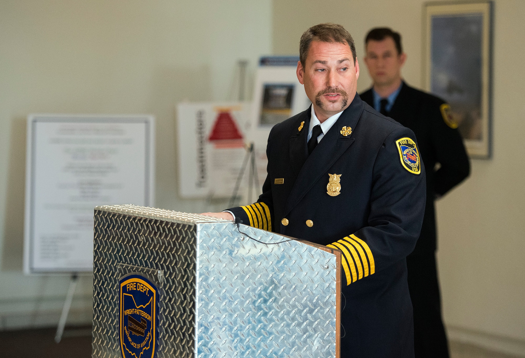 Jacob King, 788th Civil Engineering Squadron fire chief, speaks Nov. 21, 2018, during a memorial honoring Wright-Patterson Air Force Base, Ohio, firefighters who have died in the line of duty. The event was held in Building 266 on the anniversary of a fire that destroyed a previous structure on that site killing two firefighters. (U.S. Air Force photo by R.J. Oriez)