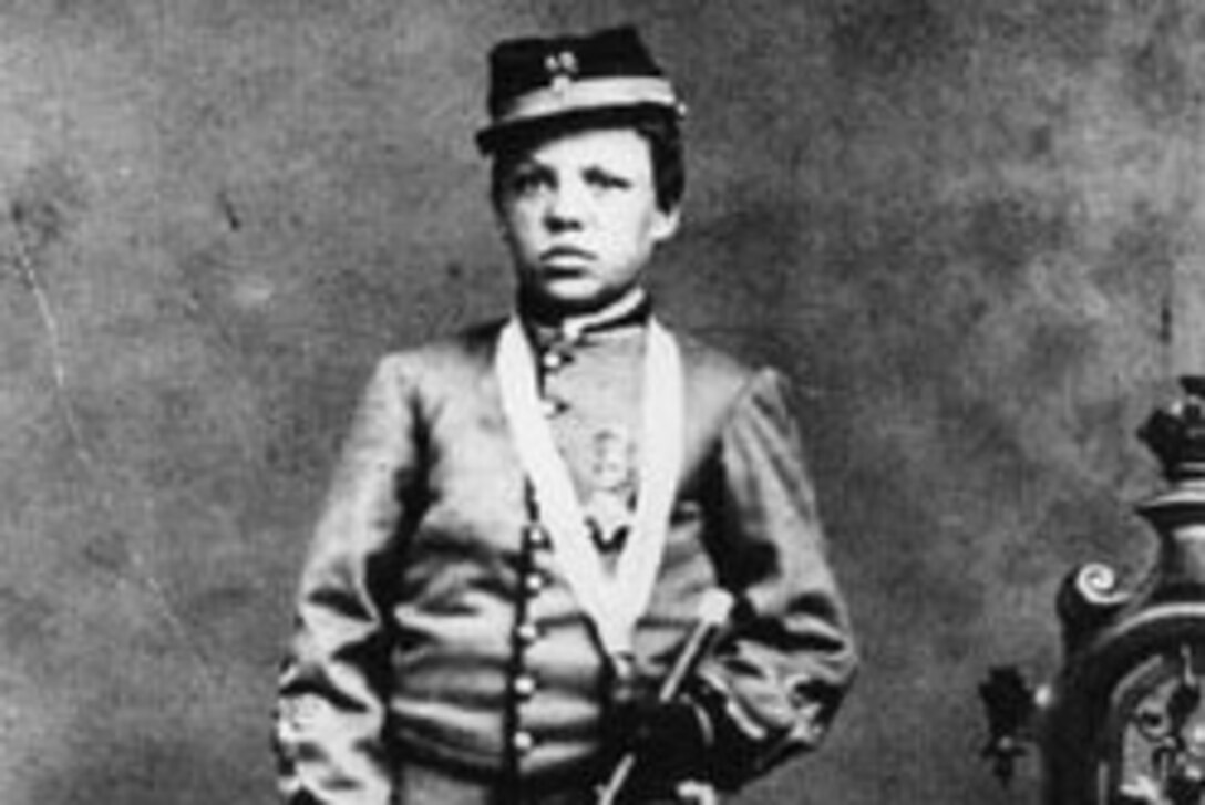 Young boy wearing Union Army uniform holds drum, circa 1861