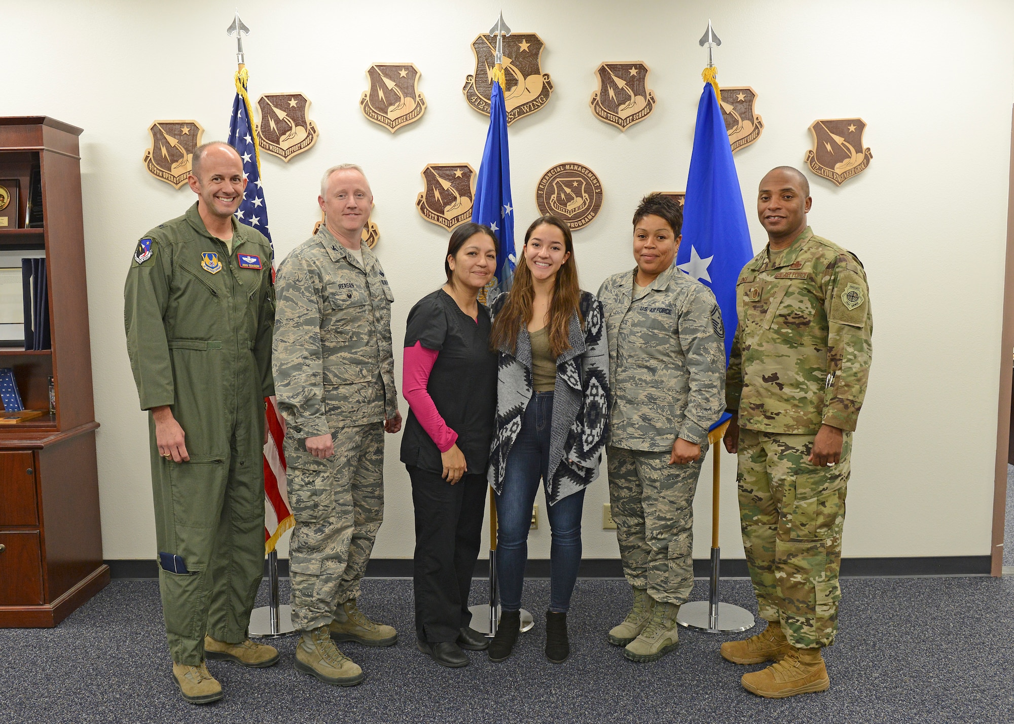 From left to right: Brig. Gen. E. John Teichert, 412th Test Wing commander; Col. Kirk Reagan, 412th TW vice commander; Lorena Rodriguez, 412th Medical Group; Amanda Rodriguez; Senior Master Sgt. Cortney Jones, Desert High School Junior ROTC instructor; and Chief Master Sgt. Roosevelt Jones, 412th TW command chief; pose for a group photo after Amanda learned that Kern County Congressman Kevin McCarthy (R-CA 23rd District) has endorsed her for entry into the U.S. Air Force Academy. (U.S. Air Force photo by Kenji Thuloweit)