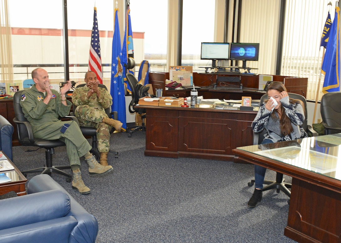 Desert High School senior Amanda Rodriguez receives a round of applause from Brig. Gen. E. John Teichert, 412th Test Wing commander (far left), and Chief Master Sgt. Roosevelt Jones, 412th TW command chief, after she learned that Kern County Congressman Kevin McCarthy (R-CA 23rd District) has endorsed her for entry into the U.S. Air Force Academy. Rodriguez was invited to the 412th Test Wing commander’s office for the surprise. (U.S. Air Force photo by Kenji Thuloweit)