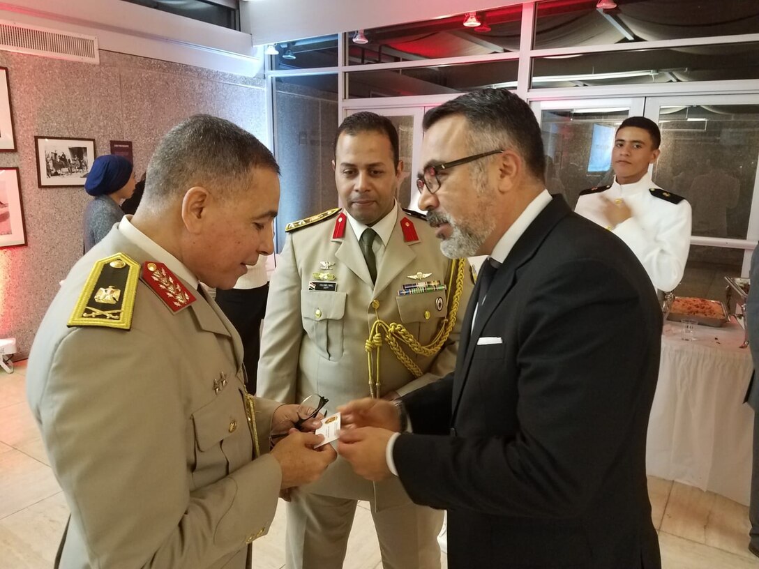 AFOSI Special Agent Jon Maldonado, Special Assistant for International Programs and Government Affairs, exchanges a business card with his Egyptian counterparts. (Photo submitted by SA Jon Maldonado)