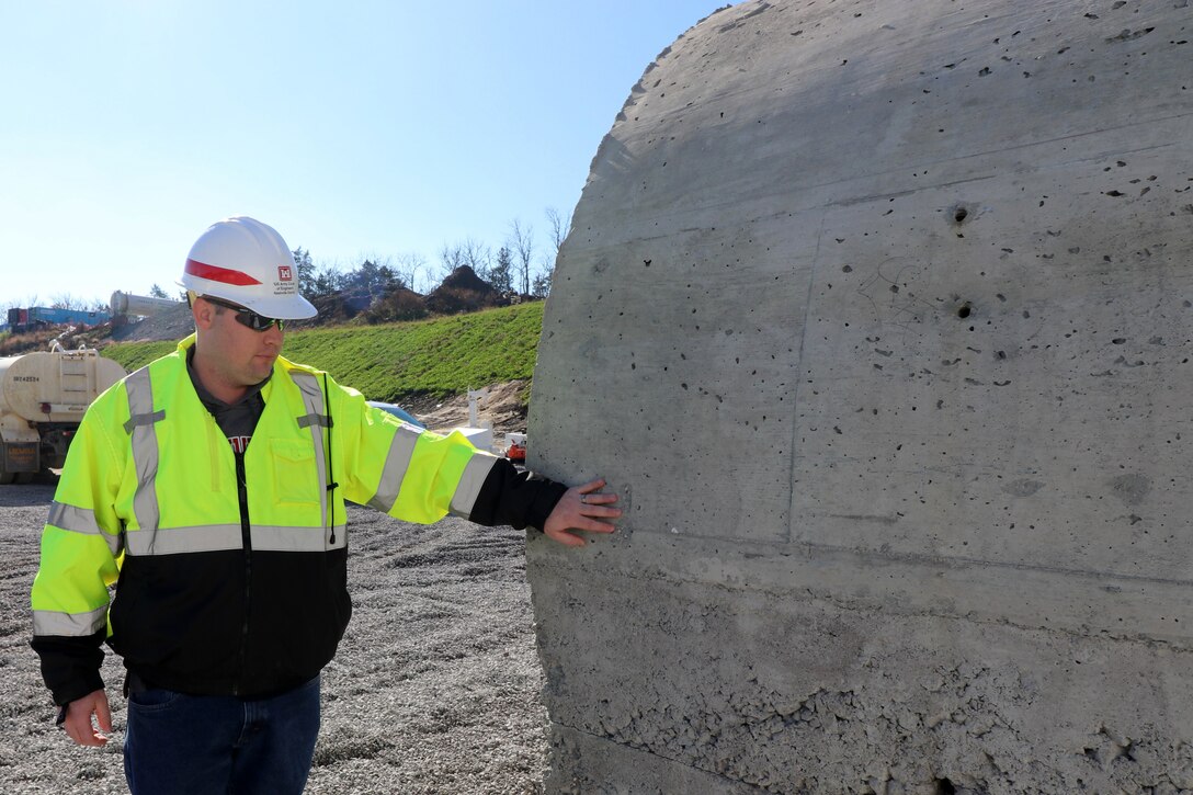 Alan Malcomb, civil engineer and Corps of Engineers contracting officer, explains at the testing platform Nov. 21, 2018 the efforts the Corps of Engineers underwent to ensure the best combination of concrete mixtures and installation methods for the roller compacted concrete berm at the Center Hill Auxiliary Dam in Silver Point, Tenn.  (USACE photo by Ashley Webster)