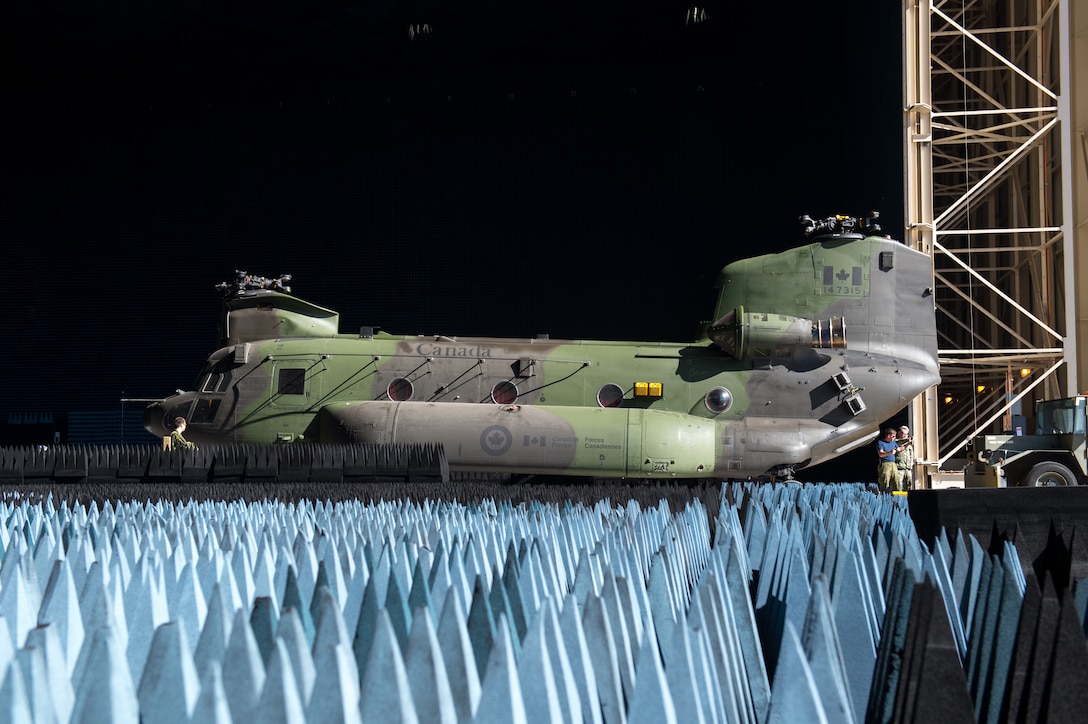 A Royal Canadian Air Force CH-147F Chinook is rolled into the Benefield Anechoic Facility Sept. 24. The BAF, operated by the 772nd Test Squadron, is the largest anechoic chamber in the world and can fit any aircraft inside. The chamber is filled with polyurethane and polyethylene pyramids designed to stop reflections of electromagnetic waves. The size of the pyramids, which are painted dark blue or black, varies depending on the particular frequency and test procedure being conducted. Aircraft systems can be tested and verified that they work properly prior to actual flight test. (U.S. Air Force photo by Kyle Larson)