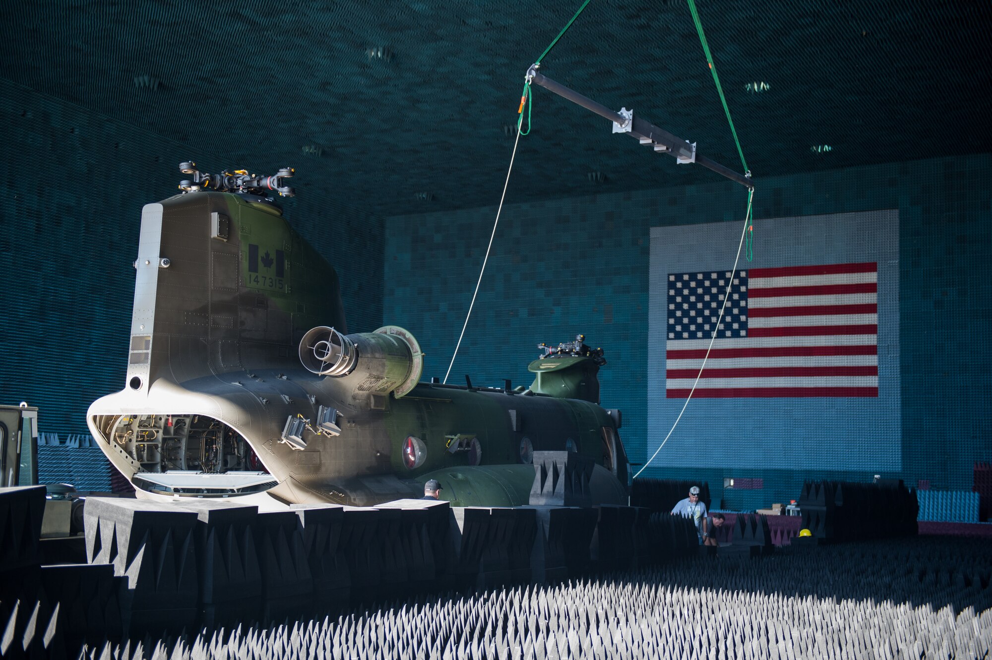 A Royal Canadian Air Force CH-147F Chinook is rolled into the Benefield Anechoic Facility Sept. 24. The BAF, operated by the 772nd Test Squadron, is the largest anechoic chamber in the world and can fit any aircraft inside. The chamber is filled with polyurethane and polyethylene pyramids designed to stop reflections of electromagnetic waves. The size of the pyramids, which are painted dark blue or black, varies depending on the particular frequency and test procedure being conducted. Aircraft systems can be tested and verified that they work properly prior to actual flight test. (U.S. Air Force photo by Kyle Larson)