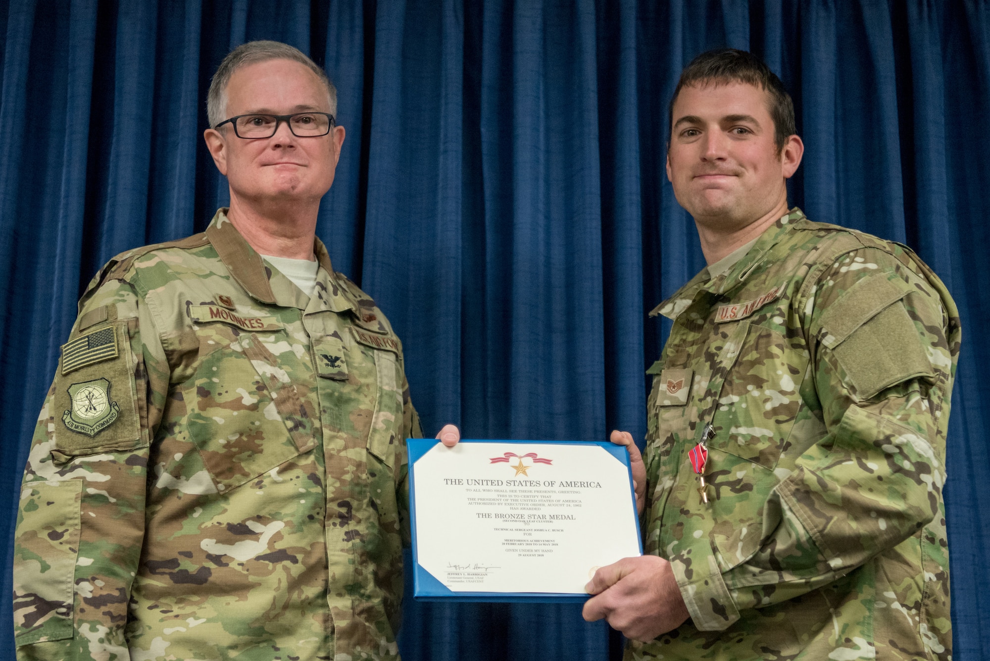 Tech. Sgt. Joshua C. Busch (right), a combat controller for the 123rd Special Tactics Squadron, receives the Bronze Star Medal from Col. David Mounkes, commander of the 123rd Airlift Wing, during a ceremony at the Kentucky Air National Guard Base in Louisville, Ky., Nov. 17, 2018. Busch distinguished himself for meritorious service with his participation in Operations Freedom’s Sentinel and Resolute Support. From February to May 2018, Busch served as a key senior tactical advisor for 17 ground combat operations, leading and coordinating 42 air-to-ground engagements while under enemy fire, directly resulting in 33 enemies killed in action. (U.S. Air National Guard photo by Staff Sgt. Joshua Horton)
