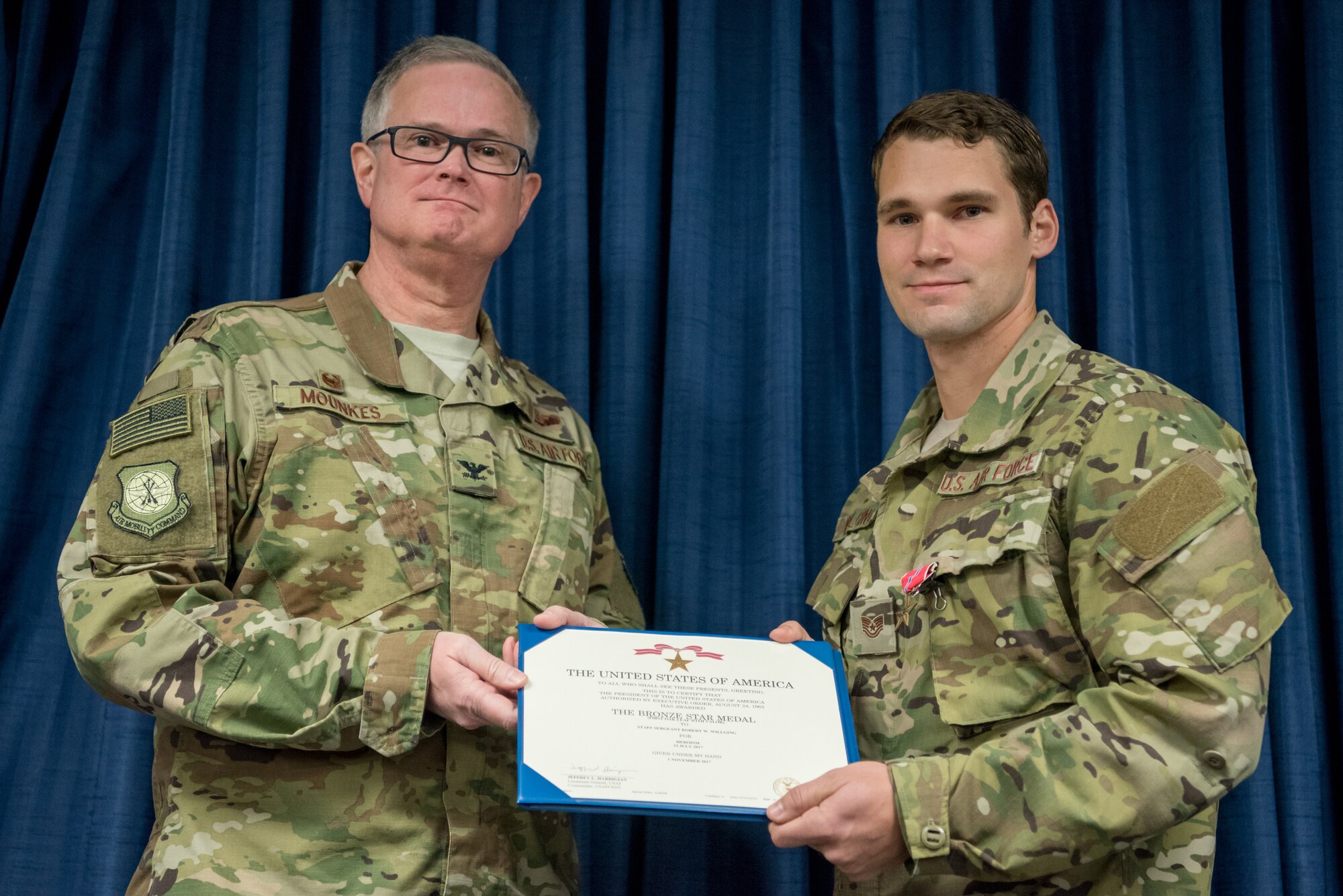 Staff Sgt. Robert W. Willging, a combat controller for the 123rd Airlift Special Tactics Squadron, is pinned with the Bronze Star Medal by Col. David Mounkes, commander of the 123rd Airlift Wing, during a ceremony at the Kentucky Air National Guard Base in Louisville, Ky., Nov. 17, 2018. Willging distinguished himself while engaged against an opposing armed force in July 2017 by displaying disregard for his own personal safety and exposing himself to hostile fire in order to coordinate and control close air support in defense of pinned-down assault elements caught in an ambush. Willging’s performance directly contributed to 81 enemies killed in action, 30 enemies wounded in action, multiple fighting positions destroyed and his team’s overall success and survival, according to the citation. (U.S. Air National Guard photo by Staff Sgt. Joshua Horton)