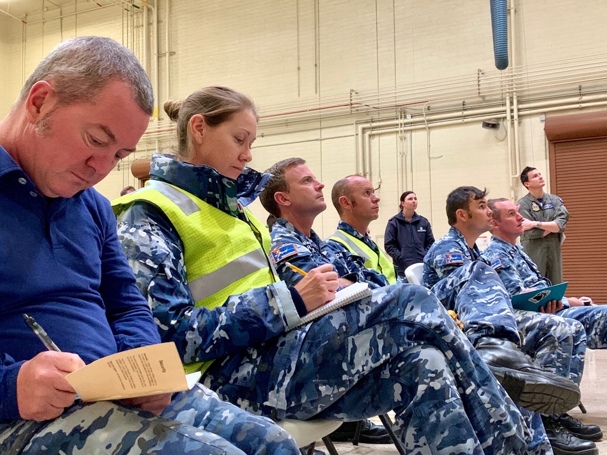 Royal Australian Air Force listen to a briefing at Luke AFB Ariz., Nov. 28, 2018. The RAAF has been preparing to send their first two RAAF F-35s to Australia. (U.S. Air Force photo by Staff Sgt. Jensen Stidham)