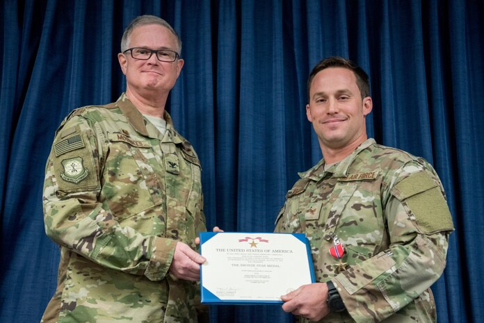 Staff Sgt. Daniel P. Keller (right), a combat controller for the 123rd Special Tactics Squadron, receives the Bronze Star Medal from Col. David Mounkes, commander of the 123rd Airlift Wing, during a ceremony at the Kentucky Air National Guard Base in Louisville, Ky., Nov. 17, 2018. Keller distinguished himself in 2017 for meritorious service in Eastern Afghanistan. His performance resulted in seven medical evacuations of American and partner forces, 209 enemies killed in action, 11 enemies wounded in action, and 163 defensive fighting positions destroyed. (U.S. Air National Guard photo by Staff Sgt. Joshua Horton)