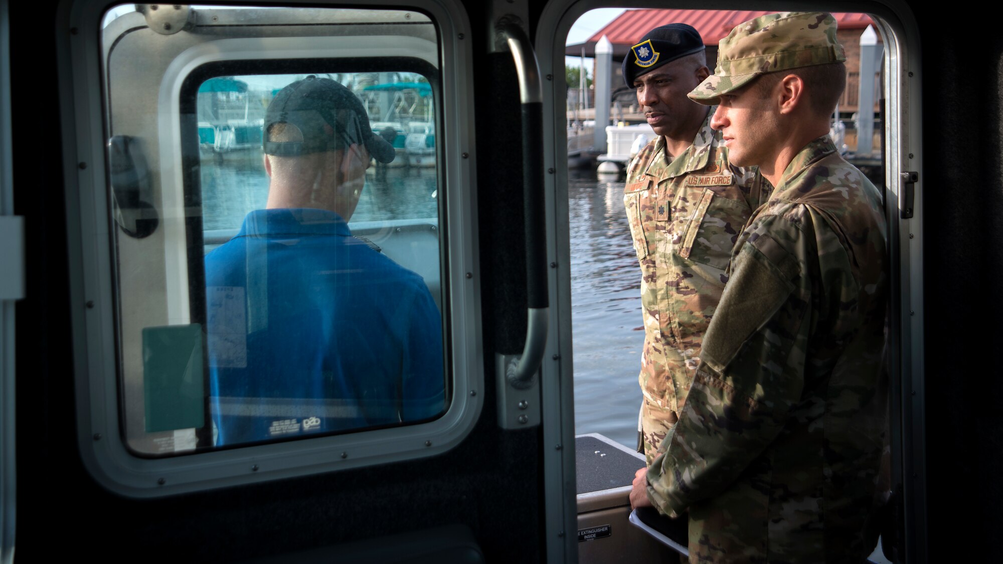 U.S. Air Force Col. Stephen Snelson, 6th Air Mobility Wing Commander, and Lt. Col. Robert Moore, 6th Security Forces Squadron Commander, talk with Tech. Sgt. James Himes, the NCO in charge of the 6th SFS Marine Patrol, at MacDill Air Force Base, Fla., Nov. 26, 2018.
