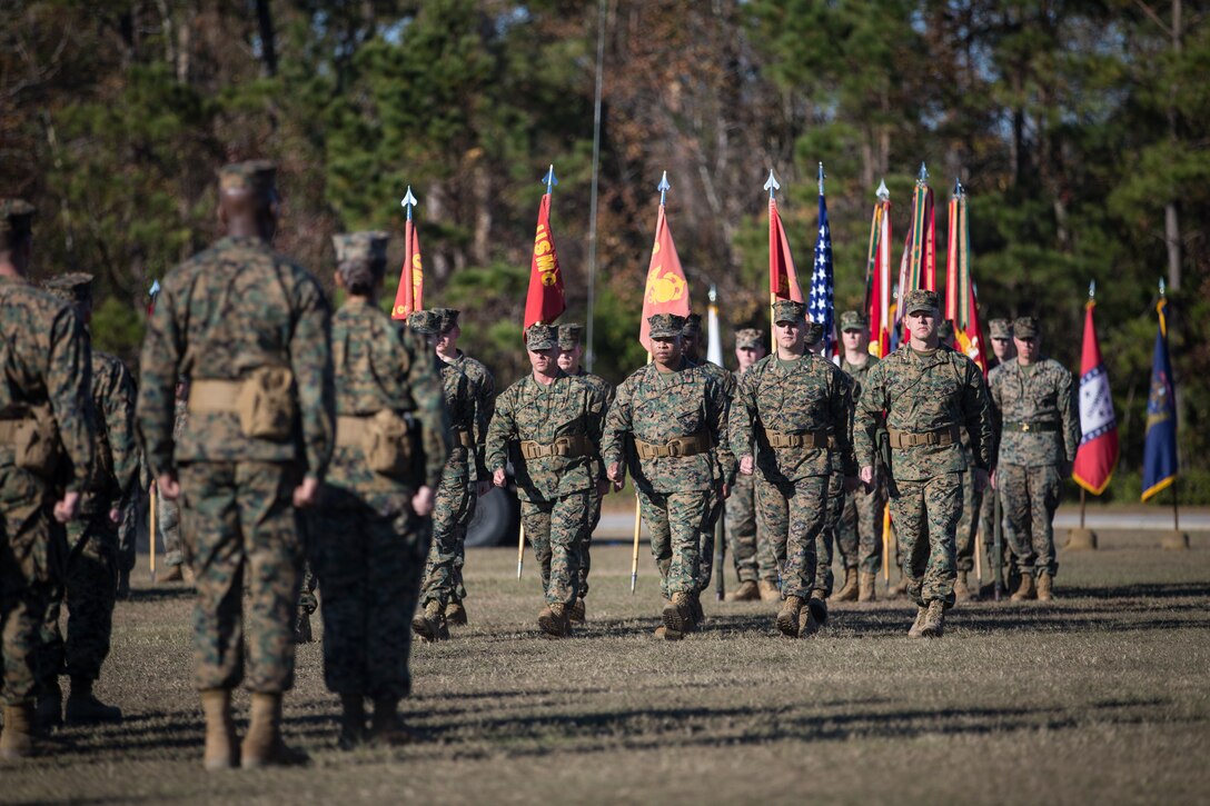 U.S. Marines with Combat Logistics Regiment 27, 2nd Marine Logistics Group, march center during a re-designation ceremony at Camp Lejeune, North Carolina, Nov. 29, 2018. The unit’s designation was changed from Headquarters Regiment to CLR-27 to focus on warfighting, deployability, and the integration of capabilities required to execute the Marine Corps mission. (U.S. Marine Corps photo by Sgt. Bethanie C. Sahms)