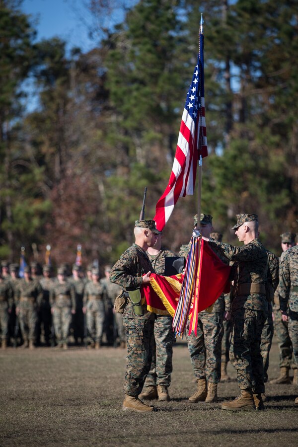 U.S. Marine Corps Col. Boyd A. Miller, right, commanding officer of Combat Logistics Regiment 27, 2nd Marine Logistics Group, and Sgt. Maj. Alex Narvaez, left, sergeant major of CLR-27, 2nd MLG, case the old battle colors of Headquarters Regiment during a re-designation ceremony at Camp Lejeune, North Carolina, Nov. 29, 2018. The unit’s designation was changed from Headquarters Regiment to CLR-27 to focus on warfighting, deployability, and the integration of capabilities required to execute the Marine Corps mission. (U.S. Marine Corps photo by Sgt. Bethanie C. Sahms)