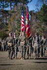 U.S. Marine Corps Col. Boyd A. Miller, commanding officer of Combat Logistics Regiment 27, 2nd Marine Logistics Group, and past commanding officers of Headquarters Regiment, 2nd MLG, stand at attention during a pass-in-review at CLR-27’s re-designation ceremony at Camp Lejeune, North Carolina, Nov. 29, 2018. The unit’s designation was changed from Headquarters Regiment to CLR-27 to focus on warfighting, deployability, and the integration of capabilities required to execute the Marine Corps mission. (U.S. Marine Corps photo by Sgt. Bethanie C. Sahms)
