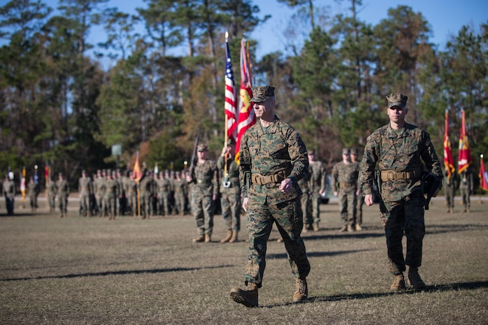 U.S. Marine Corps Col. Boyd A. Miller, commanding officer of Combat Logistics Regiment 27, 2nd Marine Logistics Group, and past commanding officers of Headquarters Regiment, 2nd MLG, stand at attention during a pass-in-review at CLR-27’s re-designation ceremony at Camp Lejeune, North Carolina, Nov. 29, 2018. The unit’s designation was changed from Headquarters Regiment to CLR-27 to focus on warfighting, deployability, and the integration of capabilities required to execute the Marine Corps mission. (U.S. Marine Corps photo by Sgt. Bethanie C. Sahms)