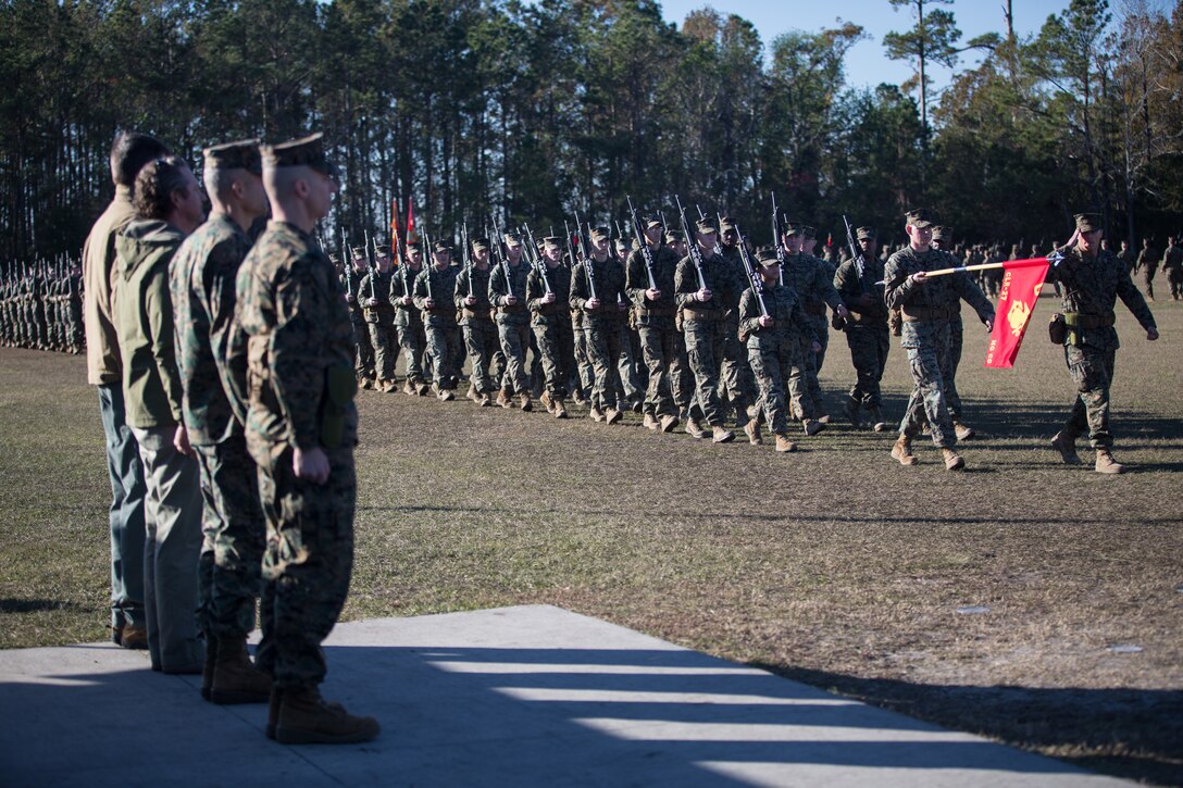 U.S. Marine Corps Col. Boyd A. Miller, commanding officer of Combat Logistics Regiment 27, 2nd Marine Logistics Group, and past commanding officers of Headquarters Regiment, 2nd MLG, stand at attention during a pass-in-review at CLR-27’s re-designation ceremony at Camp Lejeune, North Carolina, Nov. 29, 2018. The unit’s designation was changed from Headquarters Regiment to CLR-27 to focus on warfighting, deployability, and the integration of capabilities required to execute the Marine Corps mission. (U.S. Marine Corps photo by Sgt. Bethanie C. Sahms)