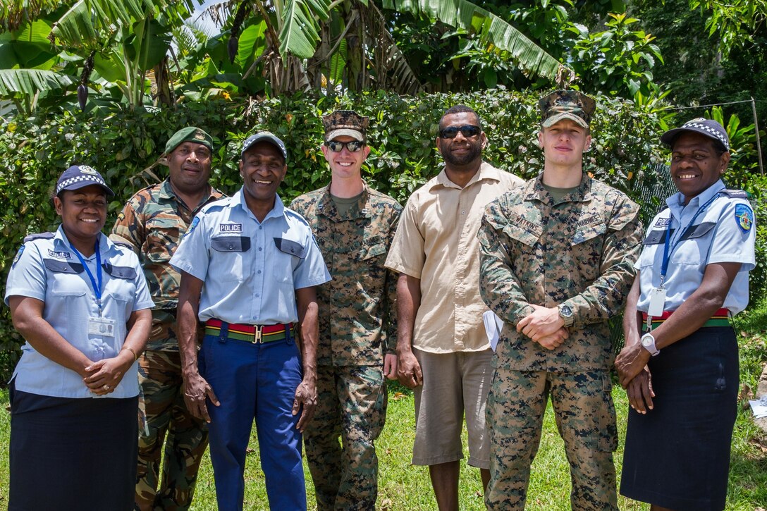 U.S. Marines Capt. Christopher Coulon, center, a civil affairs officer, and Sgt. Johnathan Watkins, second right, a ground radio repairman with Task Force Koa Moana, pose for a group photo with members of the Vanuatu Police Force, Vanuatu Mobile Force and other radio communicators at Port Vila, Efate Island, Republic of Vanuatu, Nov. 15, 2018. The Task Force exchanged radio communication capabilities with Vanuatu radio communicators in case of a humanitarian assistance and disaster and relief crises, as part of the Task Force’s continued multilateral engagements designed to strengthen and enhance relationships among the United States and partner nations in the Indo-Pacific and South Pacific regions. (U.S. Marine Corps photo by Staff Sgt. Gabriela Garcia)
