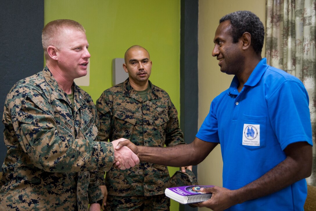 U.S. Marine Corps Lt. Col. Jacob Butz, top left, the officer in charge of Task Force Koa Moana, shakes hands with Abraham Nasak, the director for the Vanuatu National Disaster Management Office, after a meeting at Port Vila, Efate Island, Republic of Vanuatu, Nov. 12, 2018. The Marines met with the National Disaster Management Office to exchange humanitarian assistance and disaster and relief procedures as part of the Task Force’s continued multilateral engagements designed to strengthen and enhance relationships among the United States and partner nations in the Indo-Pacific and South Pacific regions. Approximately 130 U.S. Marines and Sailors with the I Marine Expeditionary Force are participating in security cooperation events with several Oceania partner nations in the U.S. Indo-Pacific Command area of responsibility while embarked on the USNS Stockham (T-AK 3017) from October November to December 2018 as part of Task Force Koa Moana. (U.S. Marine Corps photo by Staff Sgt. Gabriela Garcia)