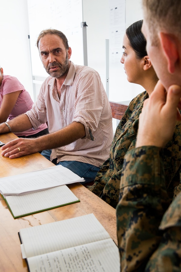 U.S. Marine Corps Capt. Christopher Coulon, right, a civil affairs officer, and U.S. Navy Hospital Corpman 2nd Class Desirae A. Montoya, second from the right, both with Task Force Koa Moana, listen to Dr. Philippe Guyant, the medical officer of the World Health Organization (WHO), at Port Vila, Efate Island, Republic of Vanuatu, Nov. 14, 2018. The Task Force met with Guyant and other WHO members to learn more about the organization, how they handle, and exchange humanitarian assistance and disaster and relief procedures in case of a crises as part of the Task Force’s continued multilateral engagements designed to strengthen and enhance relationships among the United States and partner nations in the Indo-Pacific and South Pacific regions. (U.S. Marine Corps photo by Staff Sgt. Gabriela Garcia)
