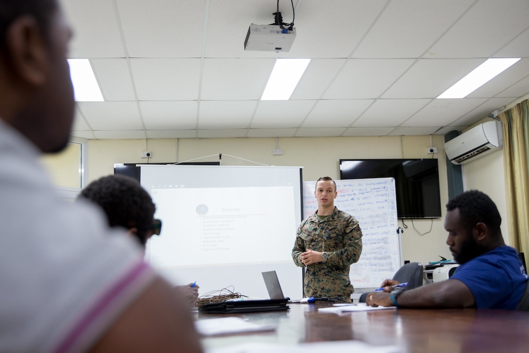 U.S. Marine Corps Sgt. Johnathan Watkins, center, a ground radio repairman with Task Force Koa Moana, teaches a Field Expedient Antennas and HF Radio Fundamentals Class to members of the Vanuatu National Disaster Management Office (NDMO) at Port Vila, Efate Island, Republic of Vanuatu, Nov. 14, 2018. The Task Force exchanged radio communication capabilities with NDMO in case of a humanitarian assistance and disaster and relief crises, as part of the Task Force’s continued multilateral engagements designed to strengthen and enhance relationships among the United States and partner nations in the Indo-Pacific and South Pacific regions. (U.S. Marine Corps photo by Staff Sgt. Gabriela Garcia)