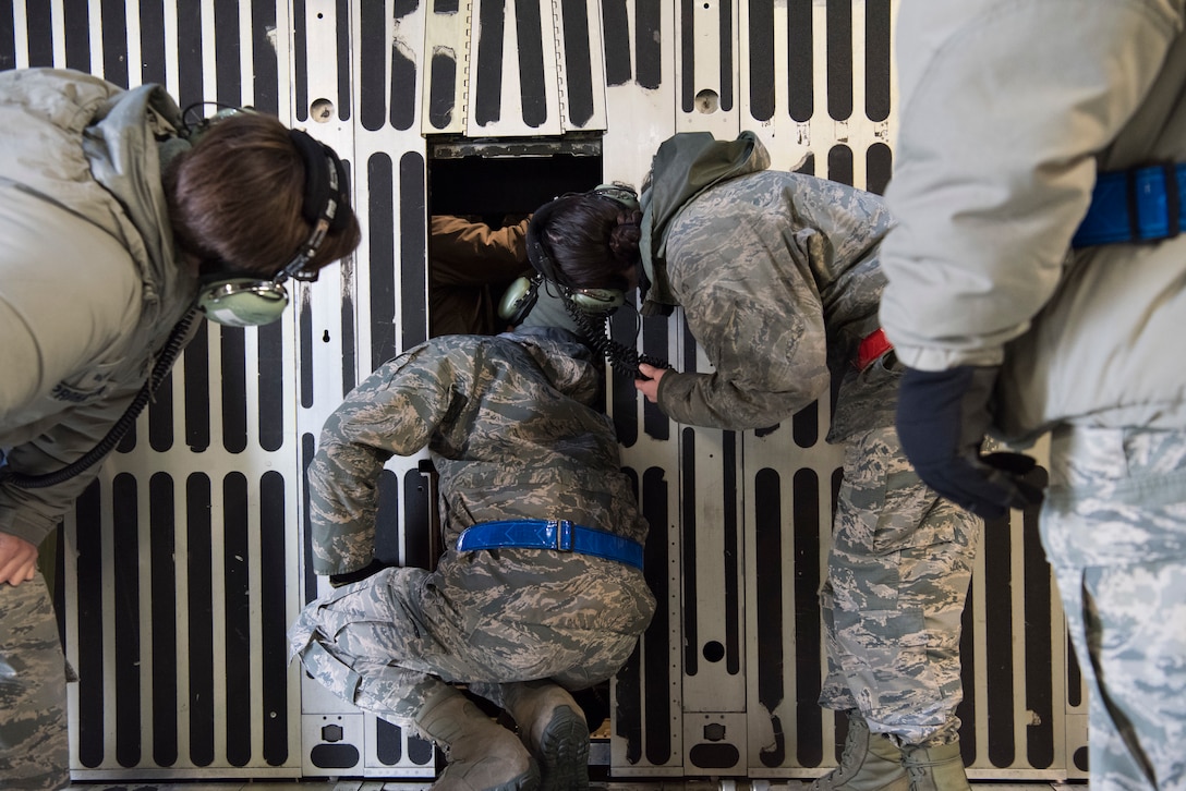 A 521st Air Mobility Operations Wing regional training center crew chief instructor shows Airmen how to inspect the visor guide roller aboard a C-5M Super Galaxy aircraft at Ramstein Air Base, Germany, Nov. 29, 2018. The C-5’s nose visor lifts to expose a front cargo door, a feature unique to the airframe. (U.S. Air Force photo by Staff Sgt. Aaron J. Jenne)