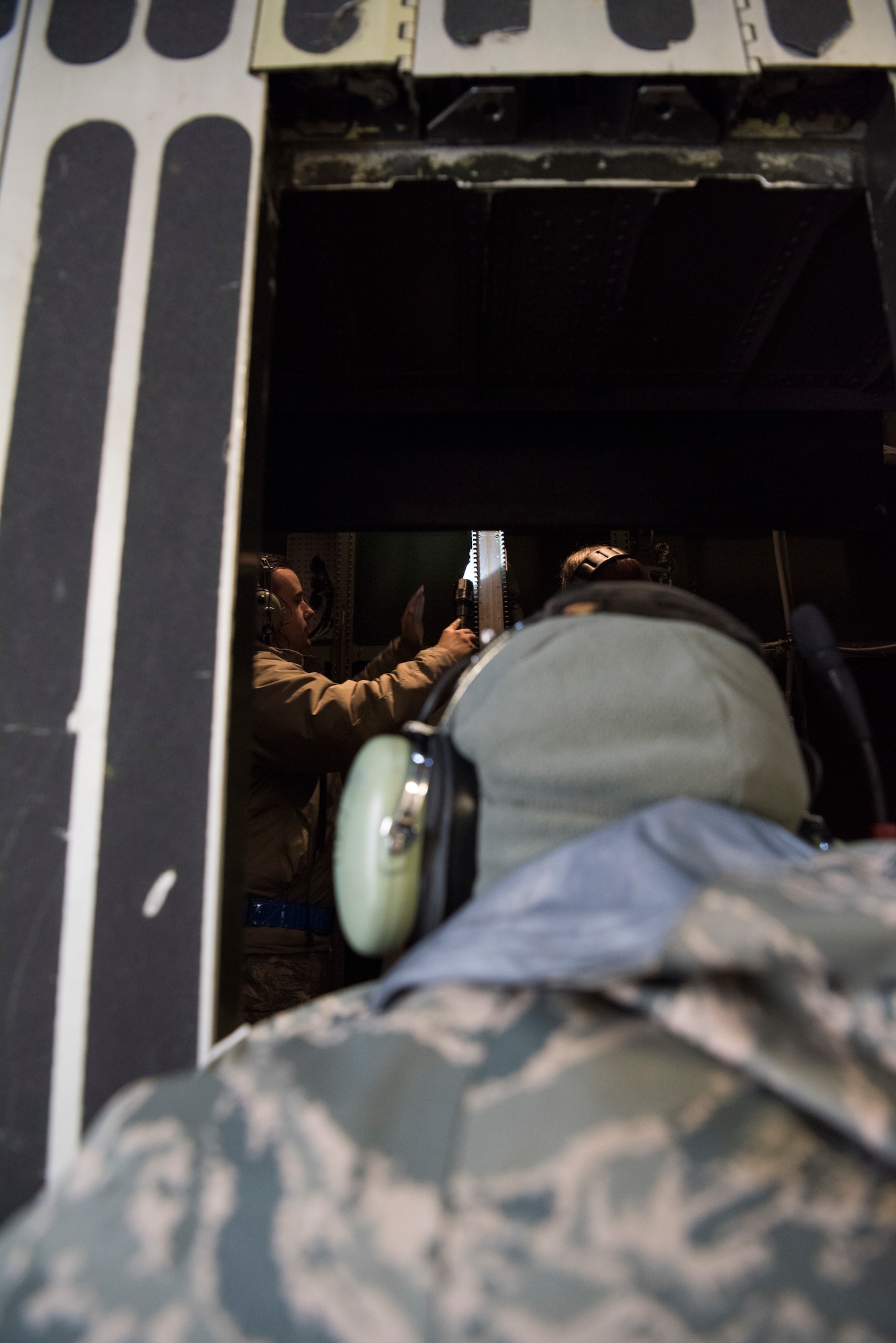 Staff Sgt. Ryan Johnson (back), 521st Air Mobility Operations Wing regional training center crew chief instructor, demonstrates the inspection of the visor guide roller aboard a C-5M Super Galaxy aircraft at Ramstein Air Base, Germany, Nov. 29, 2018. The nose visor on a C-5 lifts to expose a front cargo door, a feature unique to the airframe. (U.S. Air Force photo by Staff Sgt. Aaron J. Jenne)