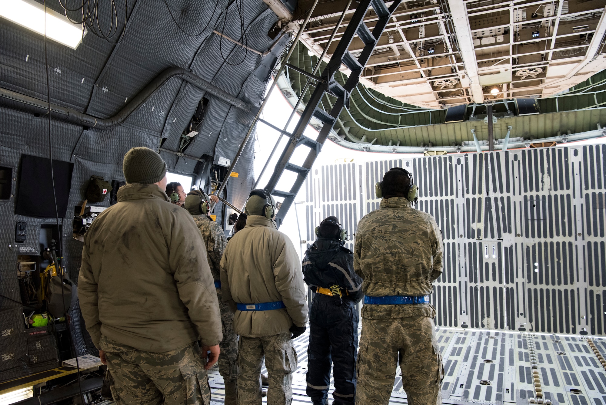 Airmen watch as a nose visor rises into place aboard a C-5M Super Galaxy aircraft at Ramstein Air Base, Germany, Nov. 29, 2018. Regional training center instructors from the 521st Air Mobility Operations Wing, headquartered at Ramstein AB, trained nearly 60 aircraft maintainers and 30 aerial port personnel on C-5 operations during a two-week training session. (U.S. Air Force photo by Staff Sgt. Aaron J. Jenne)