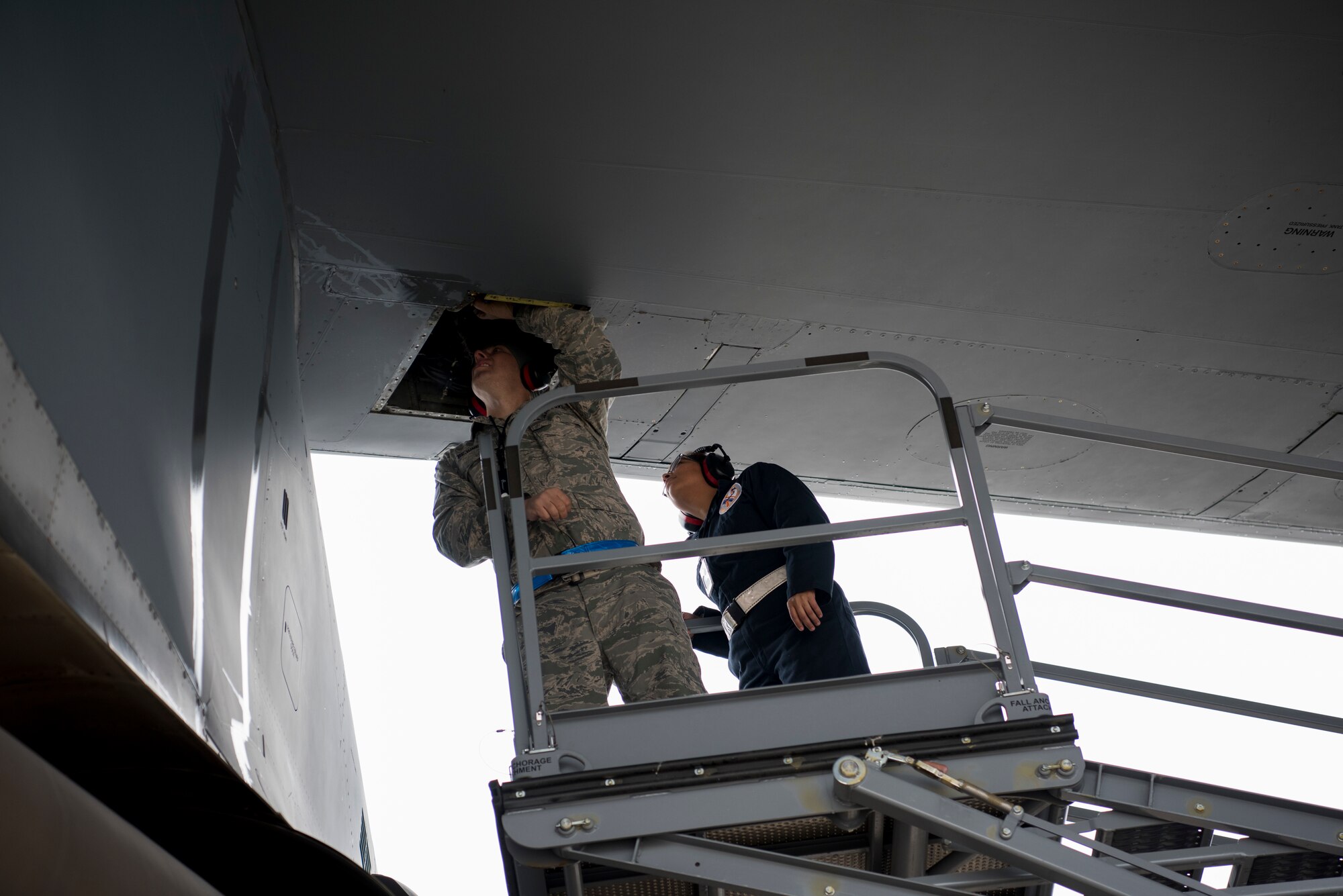 Master Sgt. Jeff Bejune, 512th Aircraft Maintenance Squadron C-17 hydraulic systems specialist, and Senior Airman Lourdes Cigarruista, 512th Maintenance Squadron C-5 hydraulic systems specialist, from Dover Air Force Base, Del., look for a hydraulic leak on a C-5M Super Galaxy at Ramstein Air Base, Germany, Nov. 29, 2018. More than 30 U.S. Air Force Reserve aircraft maintainers assigned to the 512th Airlift Wing augmented flight line maintenance operations for two weeks during a first-of-its-kind C-5 training session at Ramstein AB. (U.S. Air Force photo by Staff Sgt. Aaron J. Jenne)