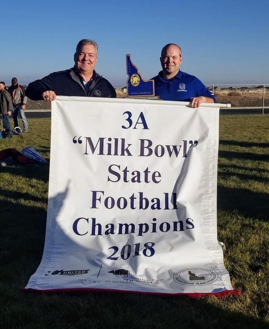 Idaho Army National Guard Staff Sgt. Tyler Richins poses for a photo with his father, Dwight Richins, after coaching Sugar-Salem High School to the Idaho 3A state football championship Nov. 17, 2018. The father-son team previously served in the Idaho Army National Guard together, where Dwight Richins retired as a lieutenant colonel in 2012, and won the 1999 3A state title as a coach/quarterback duo for Teton High School.